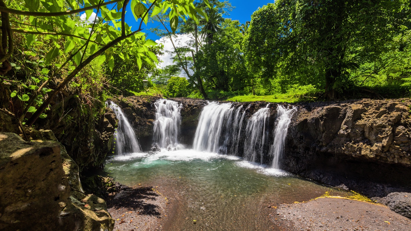 Vibrant Togitogiga falls with swimming hole on Upolu, Samoa Islands, License Type: media, Download Time: 2025-04-11T14:24:25.000Z, User: aniabartoszek, Editorial: false, purchase_order: 56530 - Guidebooks, job: Global Publishing-WIP, client: Experience South Pacific 1, other: Ania Lenihan