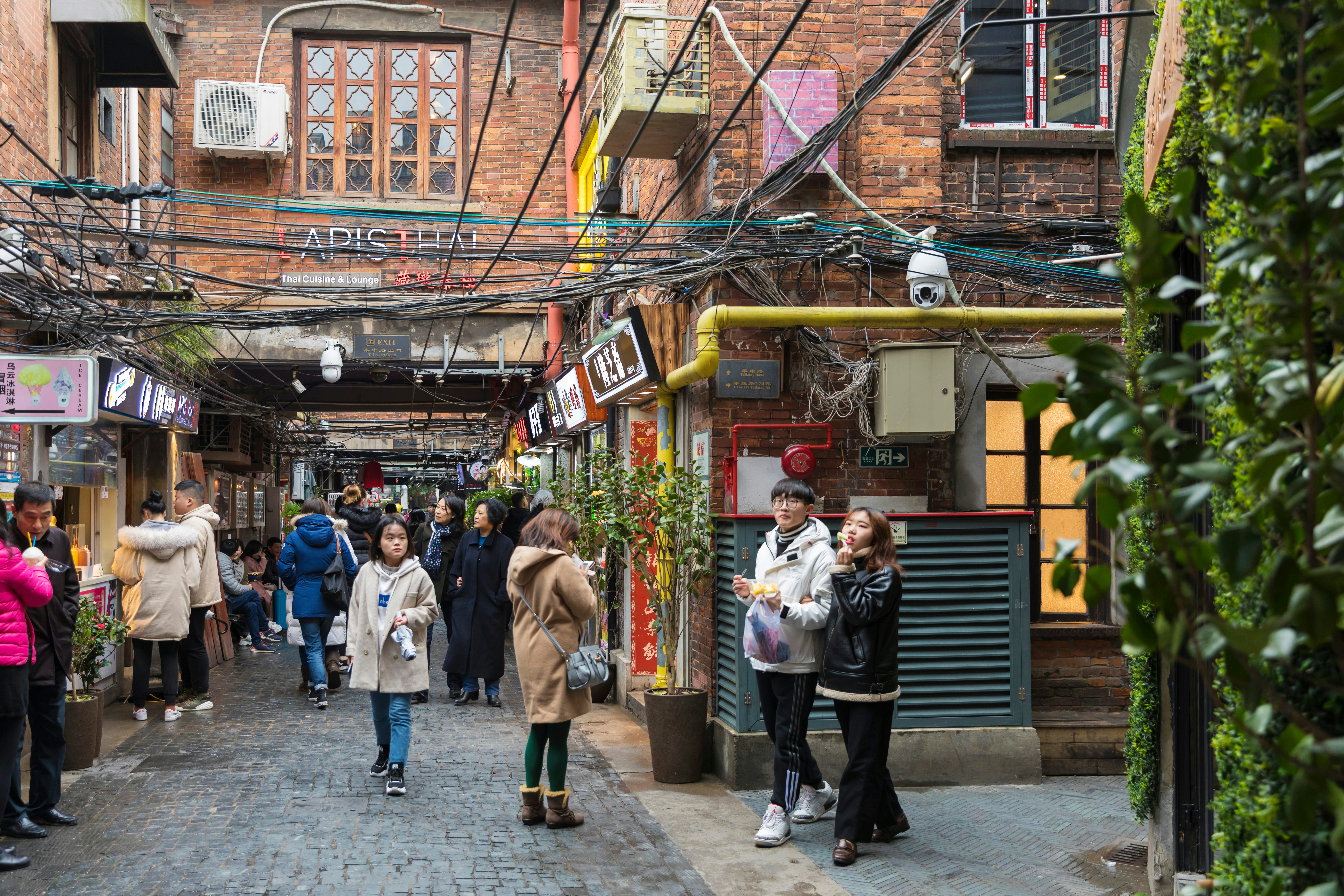 Young people exploring the lanes of Tianzifang in the former French Concession, Shanghai, China.