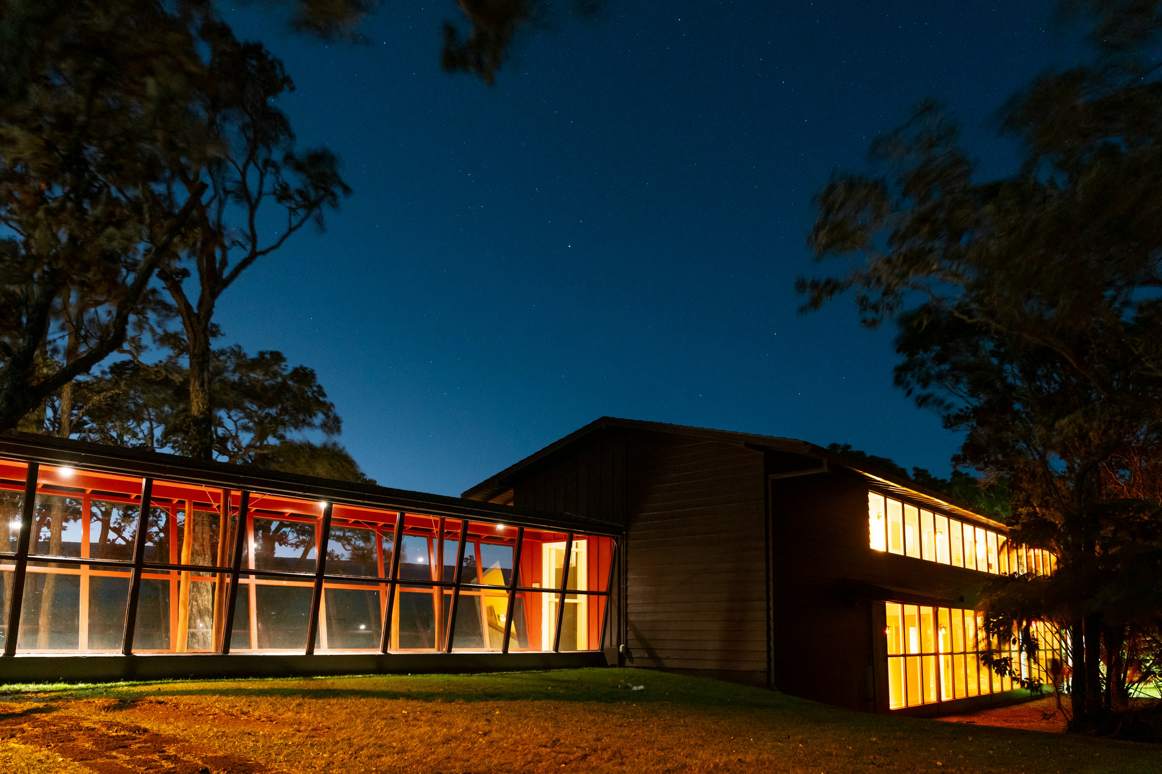 A building with a long glass walkway at night