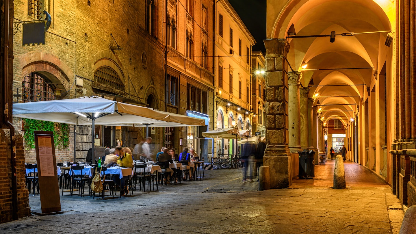 ancient, antique, arc, arcade, arch, architectural, architecture, bologna, building, cafe, center, chair, city, cityscape, cozy, emilia, europe, european, evening, historic, historical, house, italia, italian, italy, landmark, medieval, narrow, night, old, outdoor, passage, people, restaurant, romagna, street, table, terrace, tourism, tourist, town, travel, urban, view
Old narrow street with arcade in Bologna, Emilia Romagna, Italy. Night cityscape of Bologna.