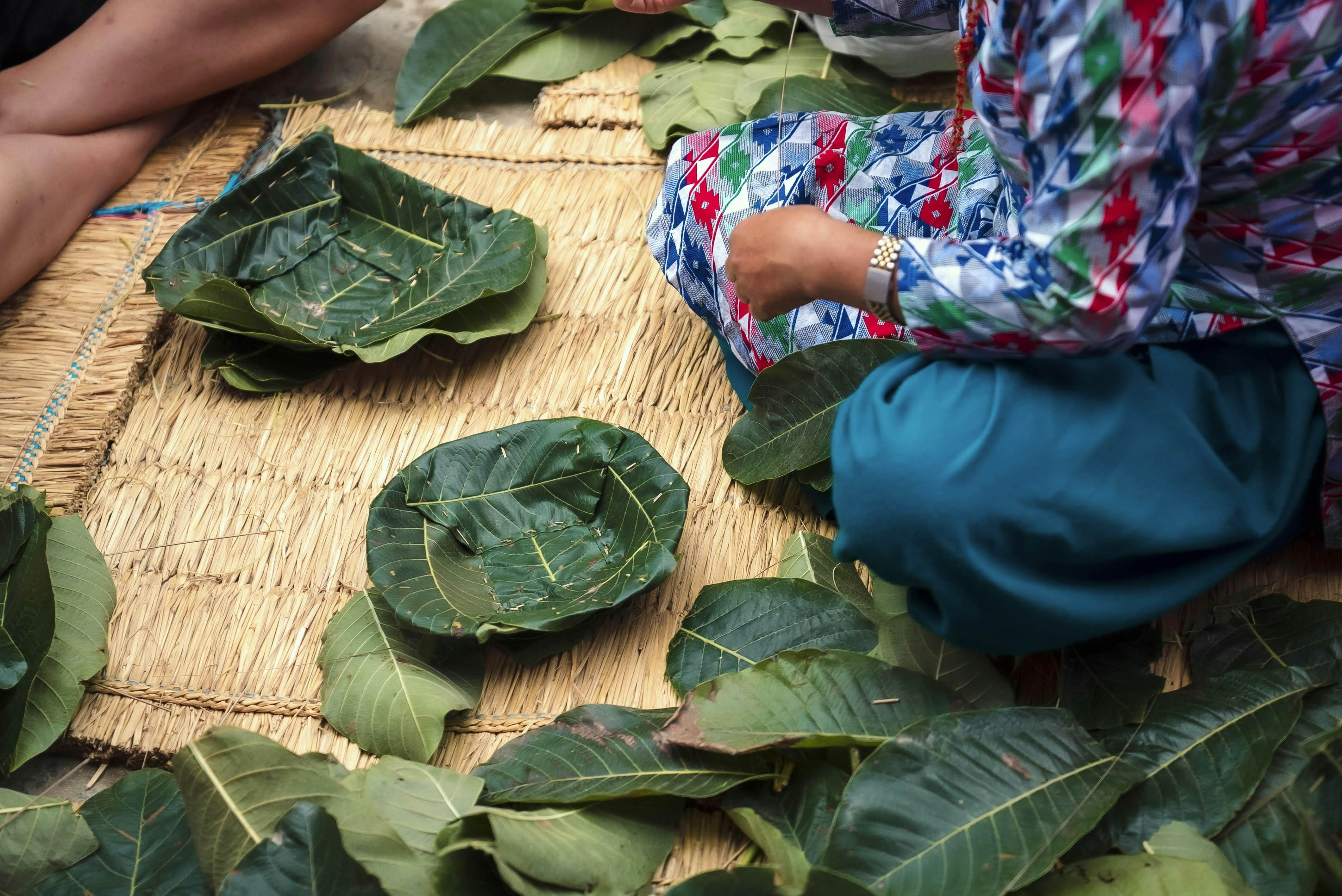 Green leaves stitched into temporary dishes.