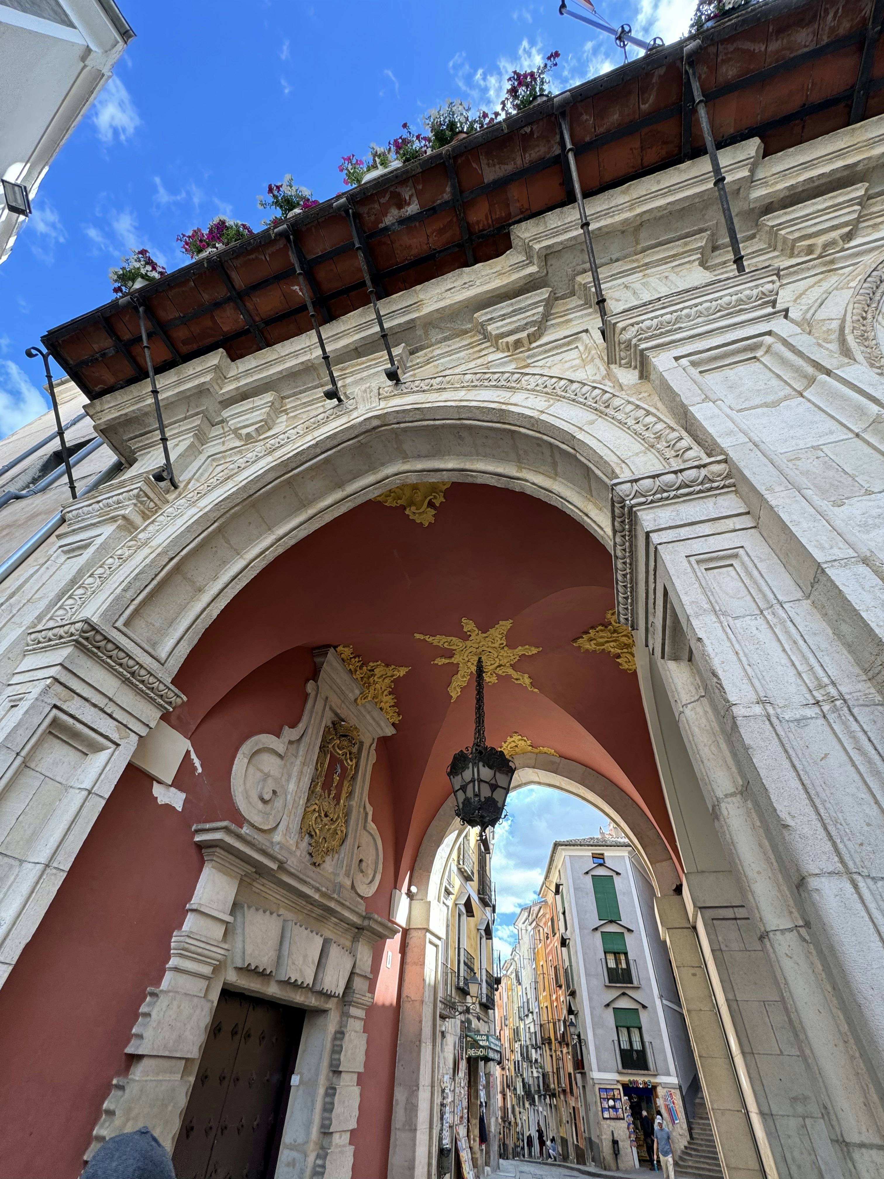 A picture of a street in Cuenca's Old Quarter through a doorway.