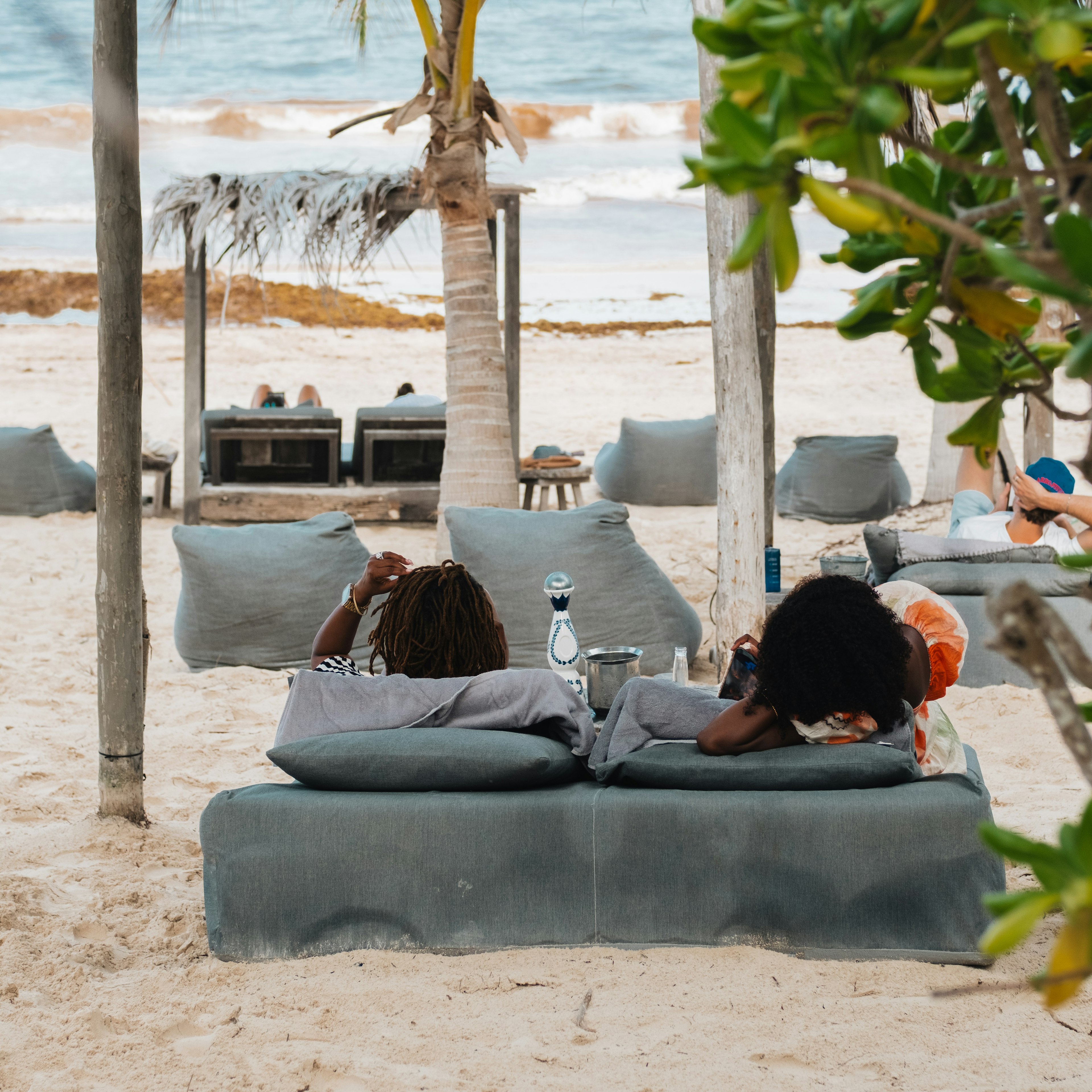 Two people lounging at at Nômade Temple Tulum