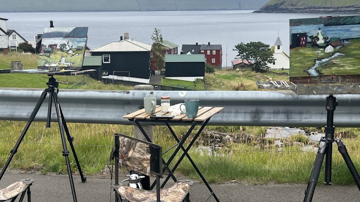 Two paintings with the village in the background and the ocean