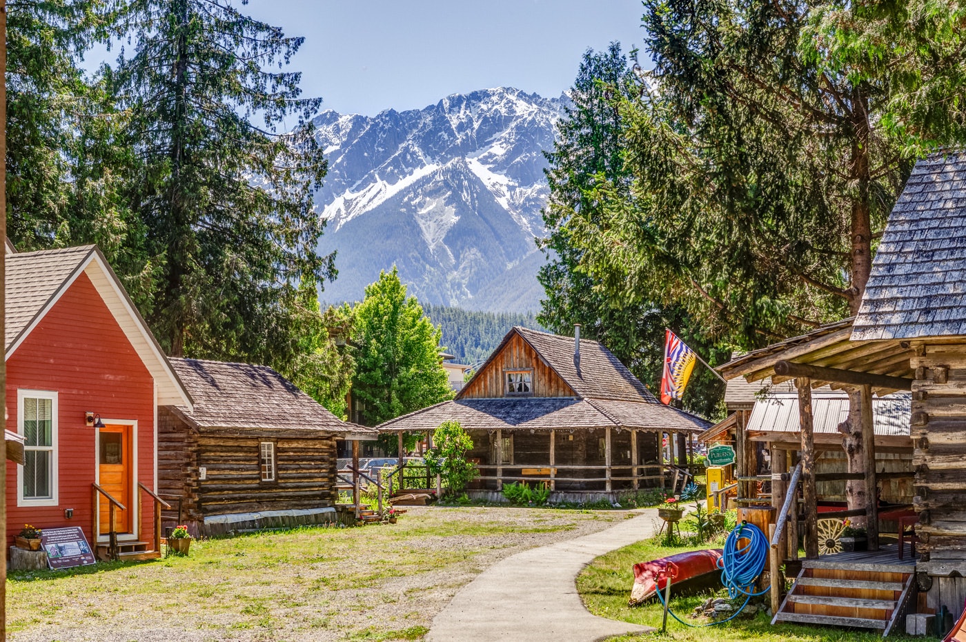 The Pemberton Museum in Pemberton, British Columbia, showcases pioneer-era cabins and heritage buildings against snowcapped mountains.
