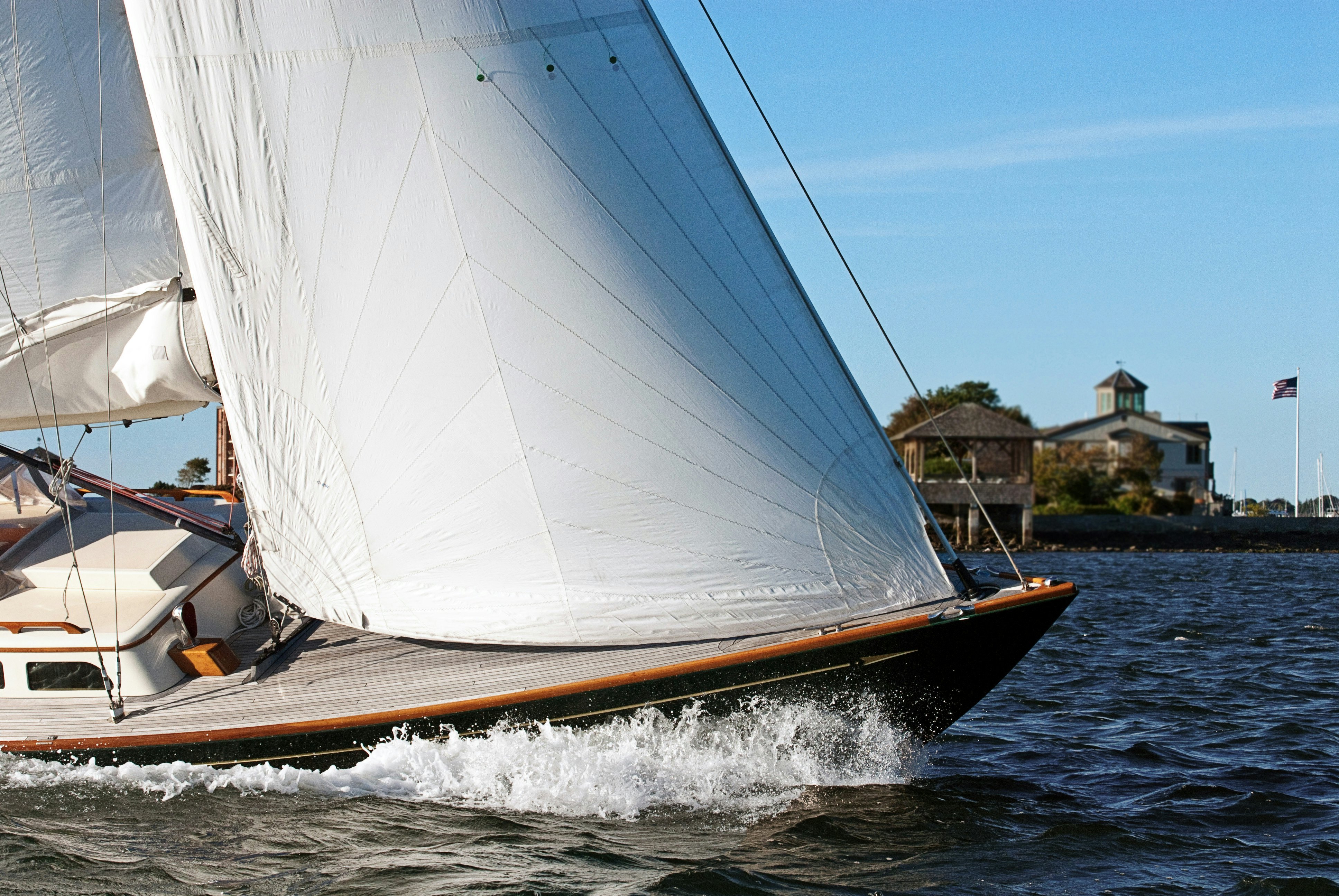 A white sailboat cuts through the Narragansett Bay off the coast of Newport, Rhode Island.