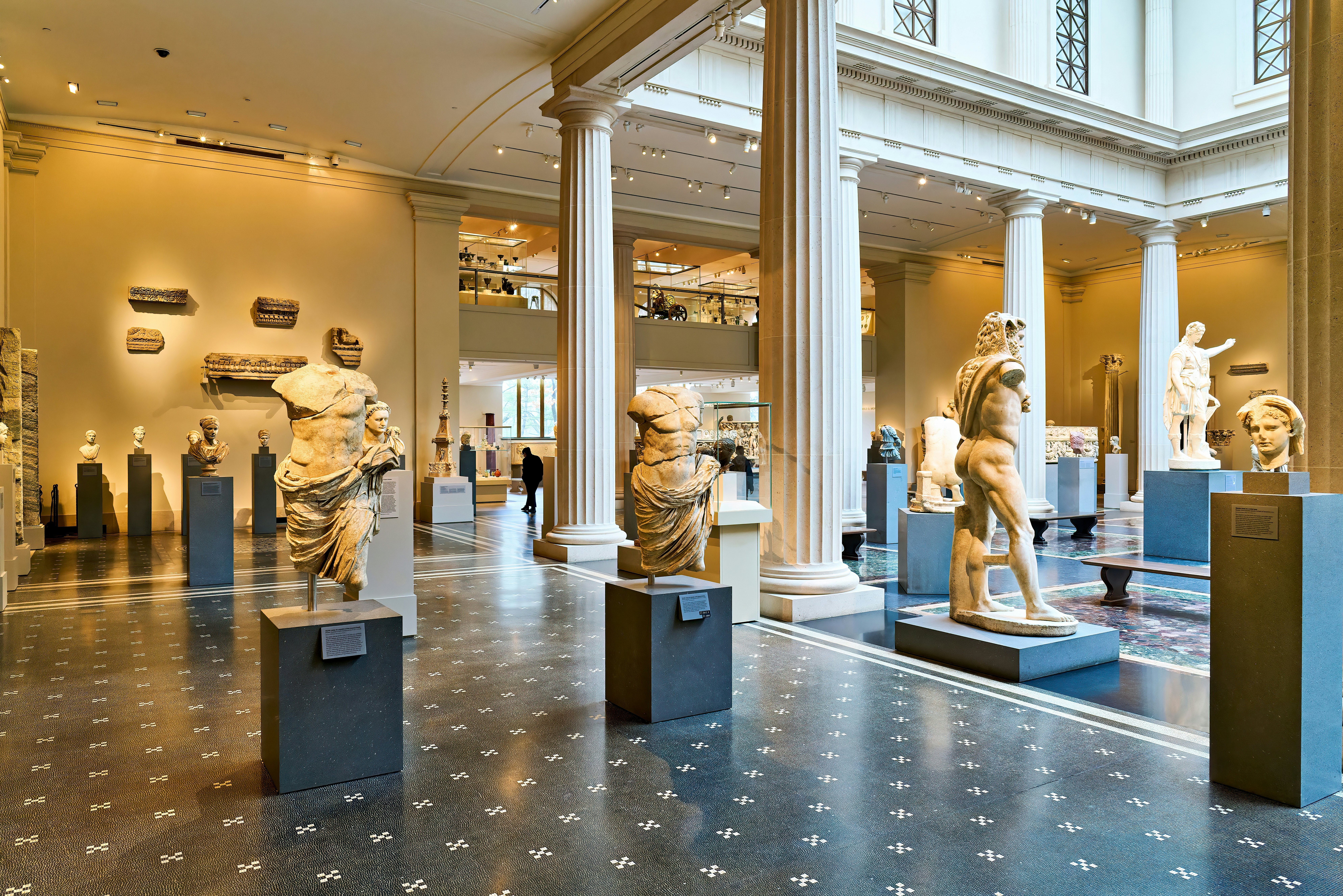 Open room of half-nude, detailed sculptures on pedestals