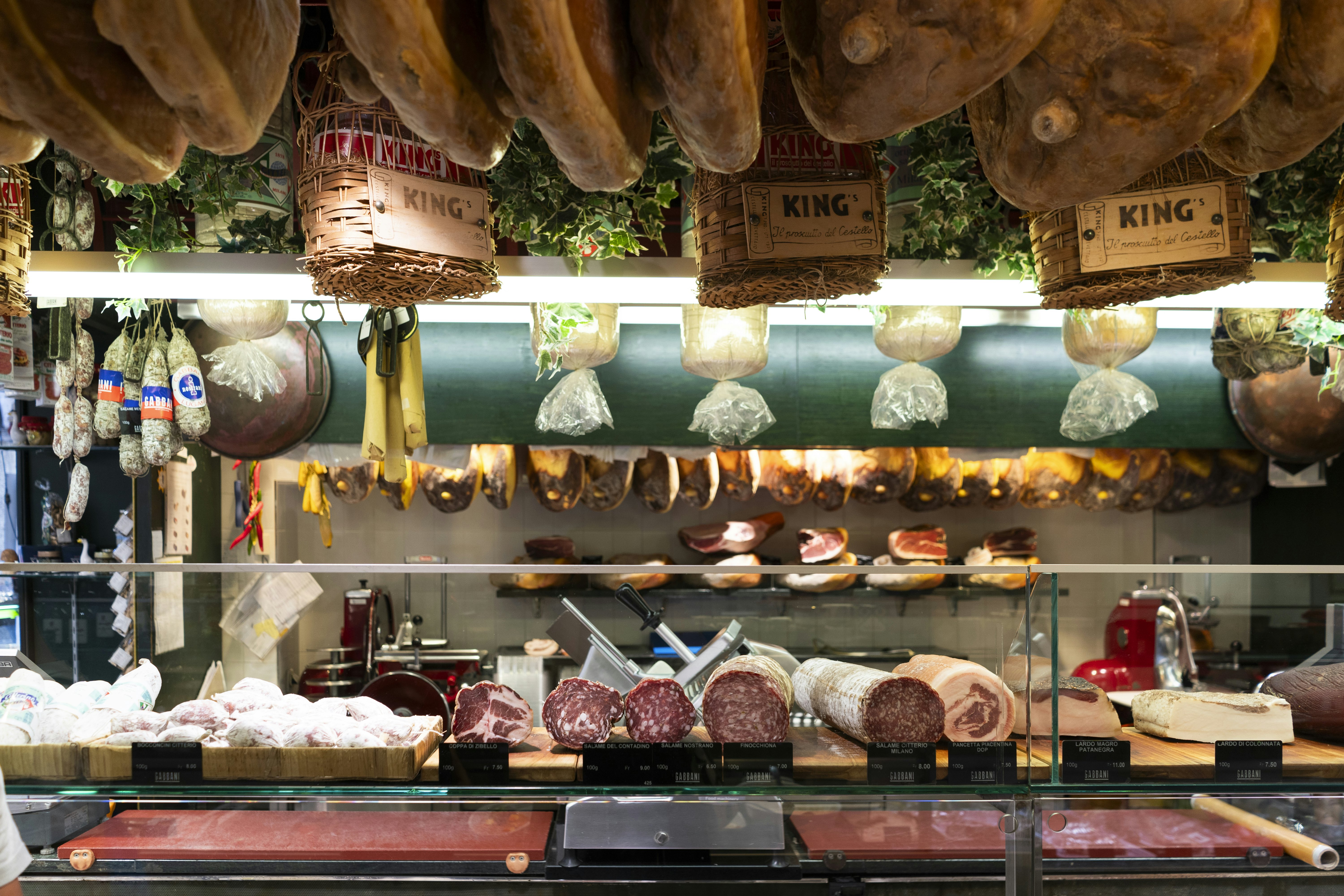 An Italian-style deli in Lugano, Switzerland, piled with hams and salamis.