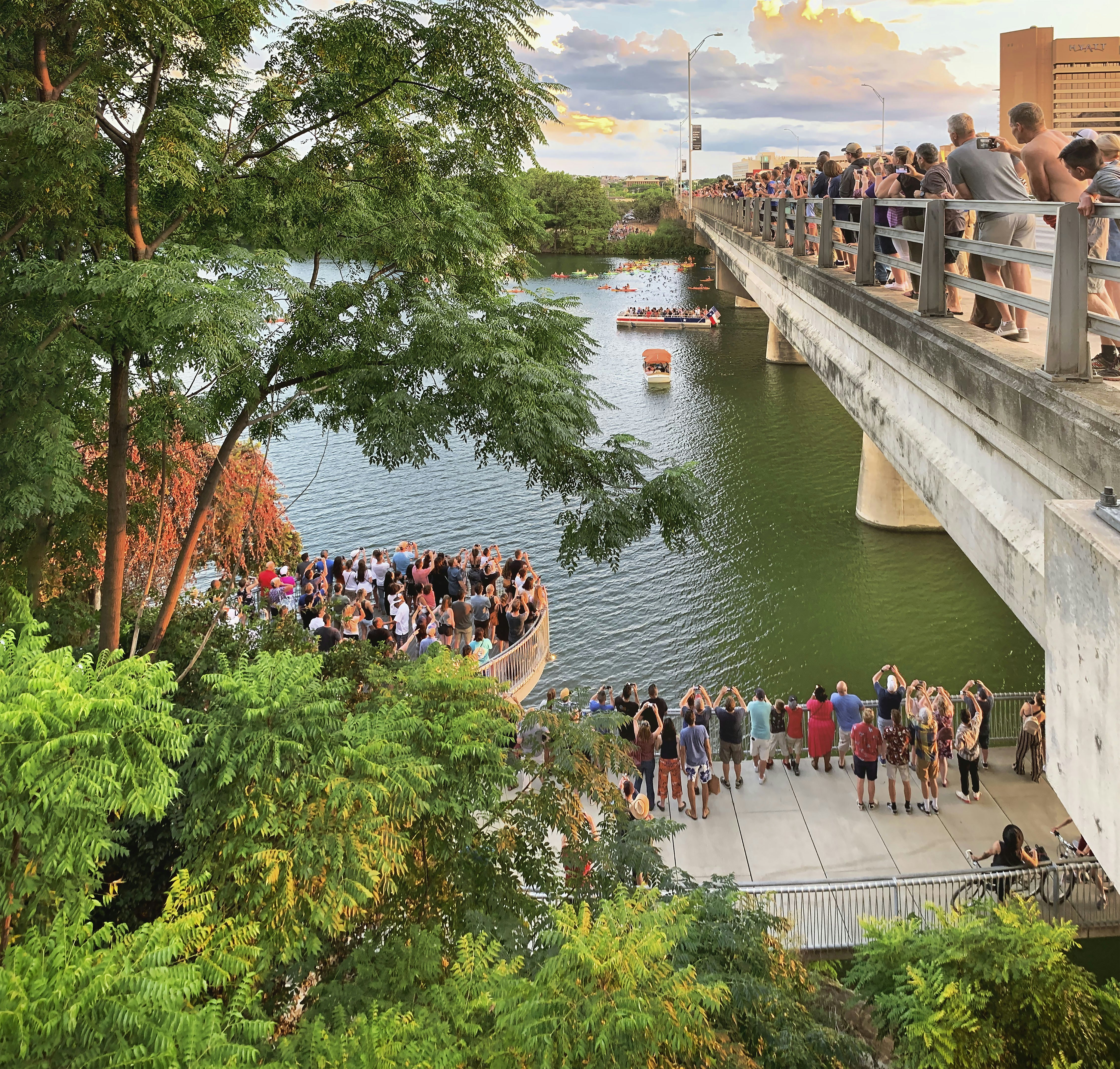 People gathered on an observation platform near water