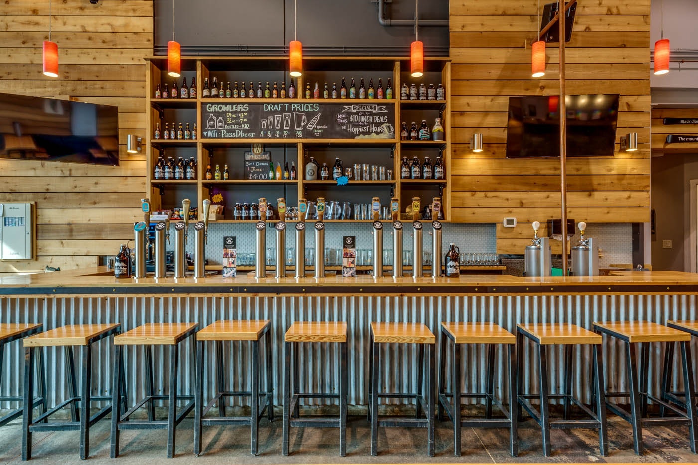 The tasting room at Whistler Brewing Company in Whistler, British Columbia, features a long bar with local spirits on tap.