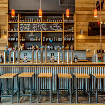 The tasting room at Whistler Brewing Company in Whistler, British Columbia, features a long bar with local spirits on tap.