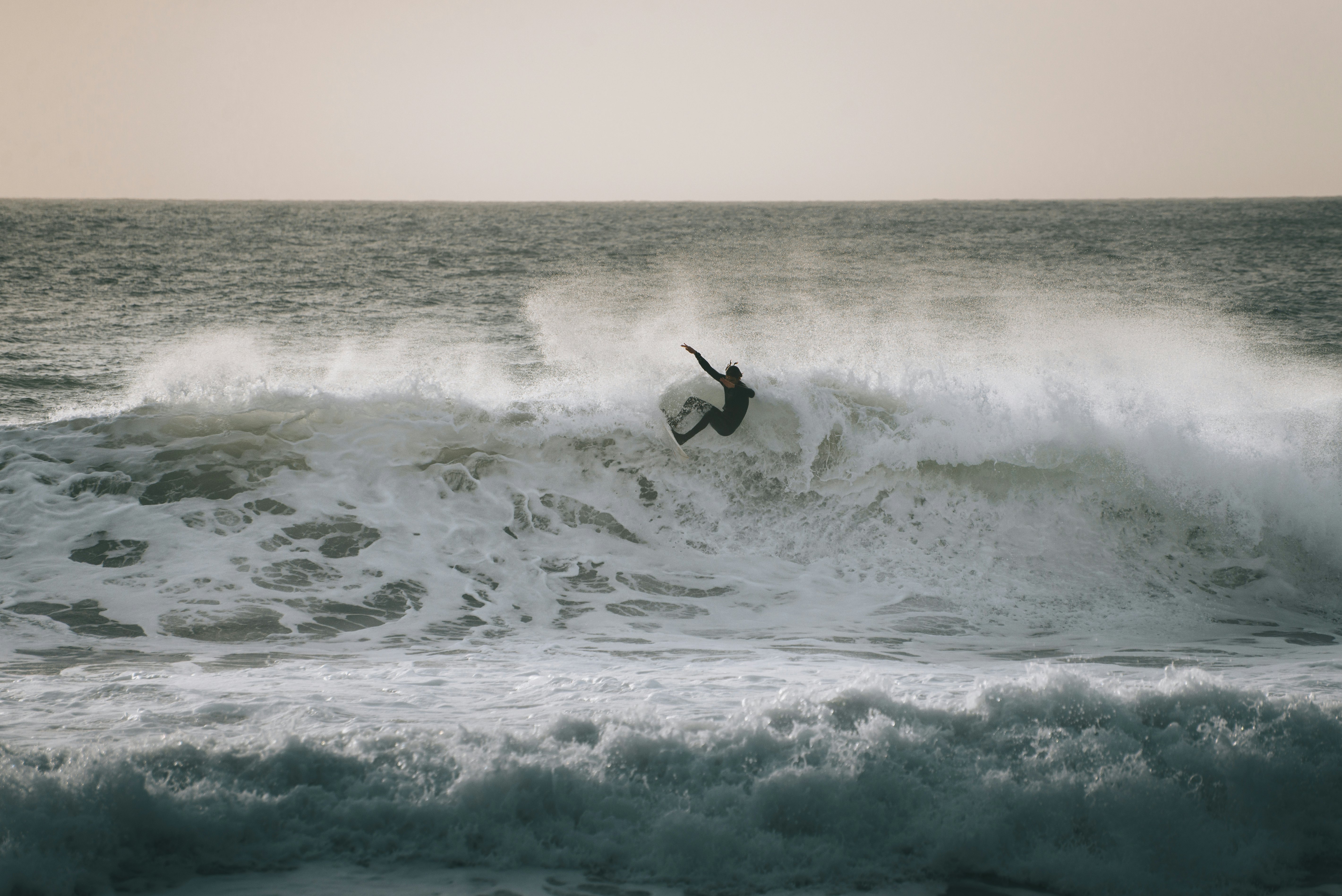 A surfer catching a big wave in Levanto, Liguria, Italy.