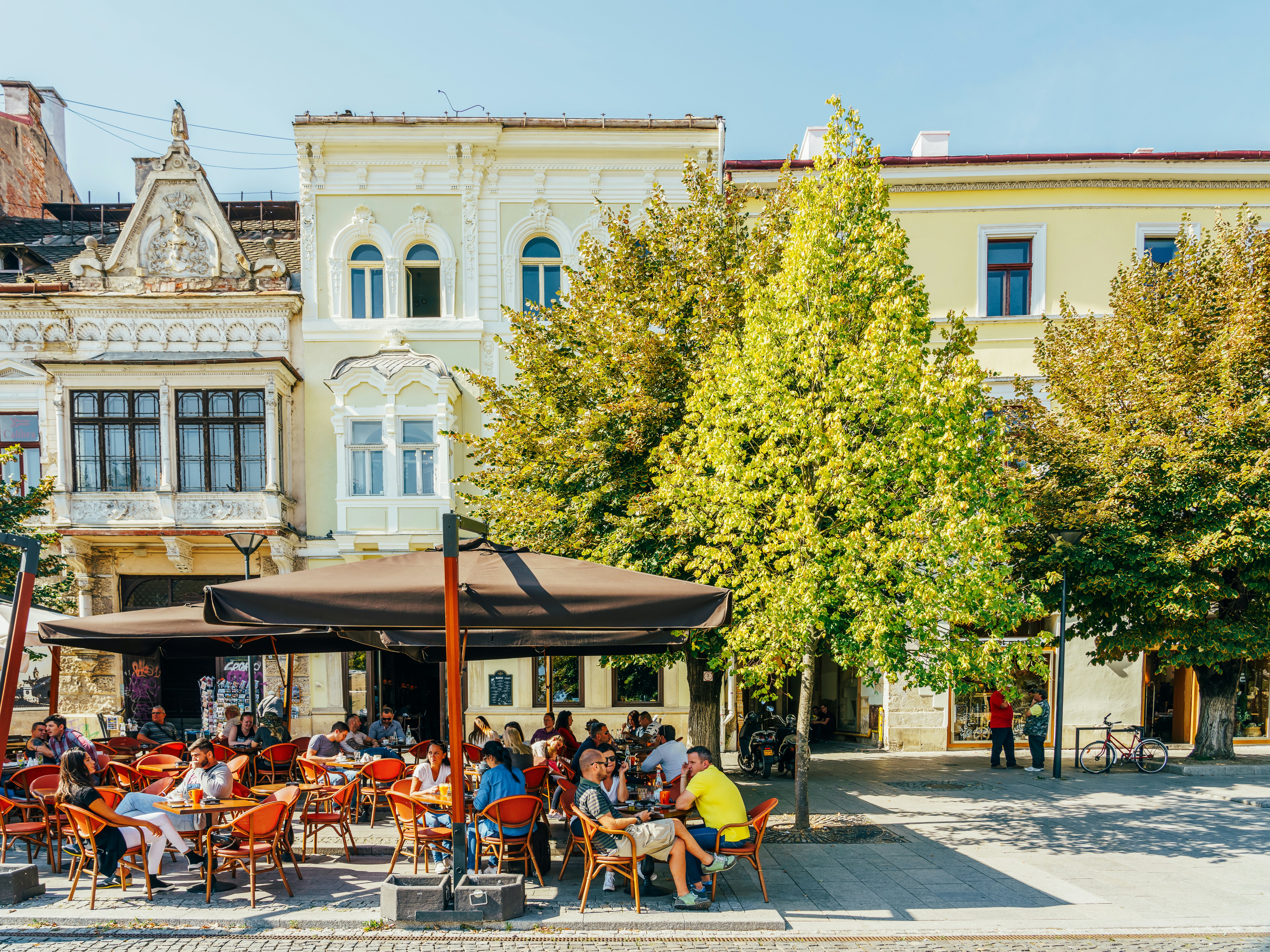 A sunny day with diners sat outside restaurants and terrace cafes.