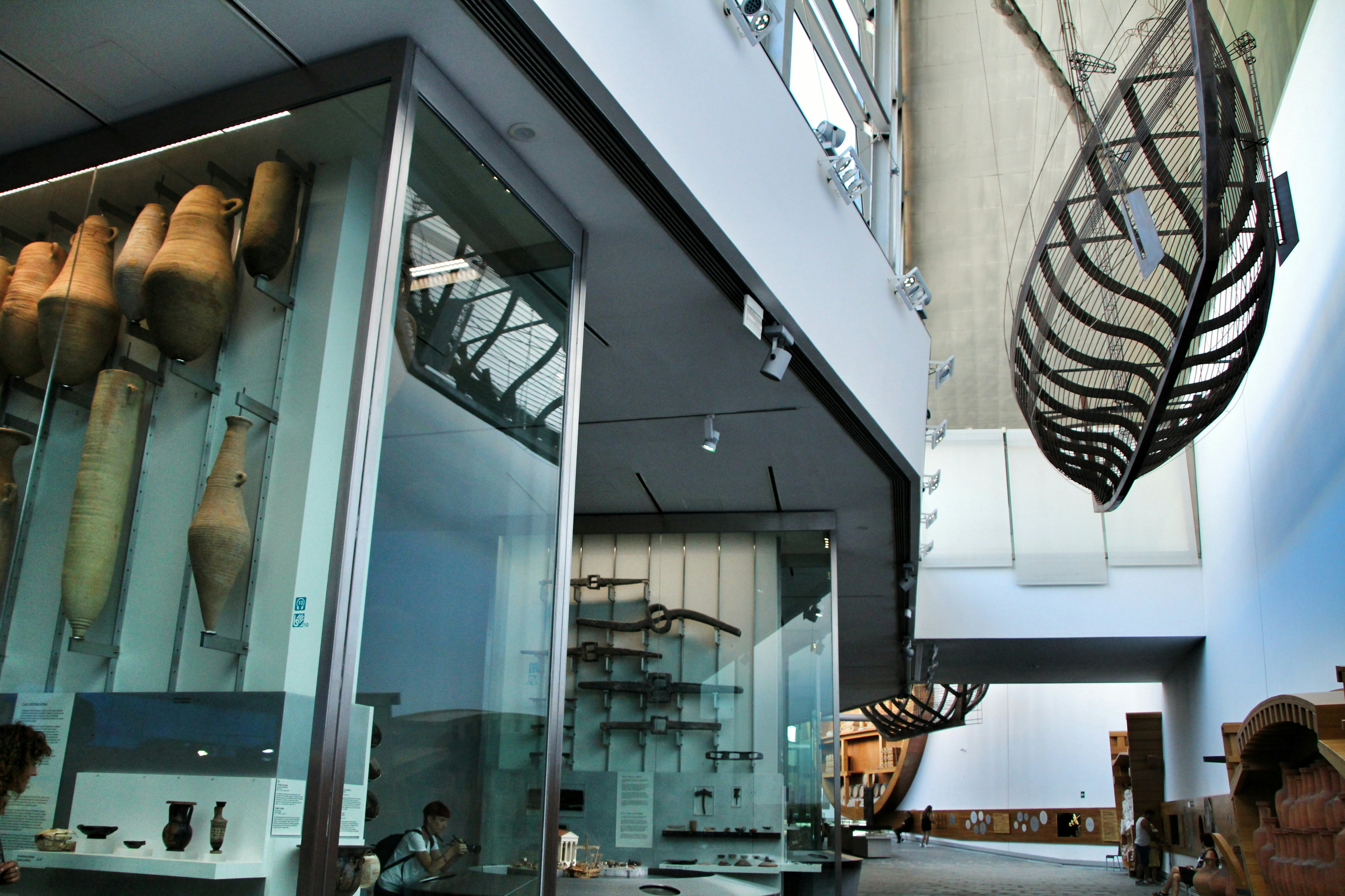 Tourists inside rooms with displays of archeological remains in the Museo Nacional de Arqueología Subacuática (the Underwater Museum of Cartagena), Spain.