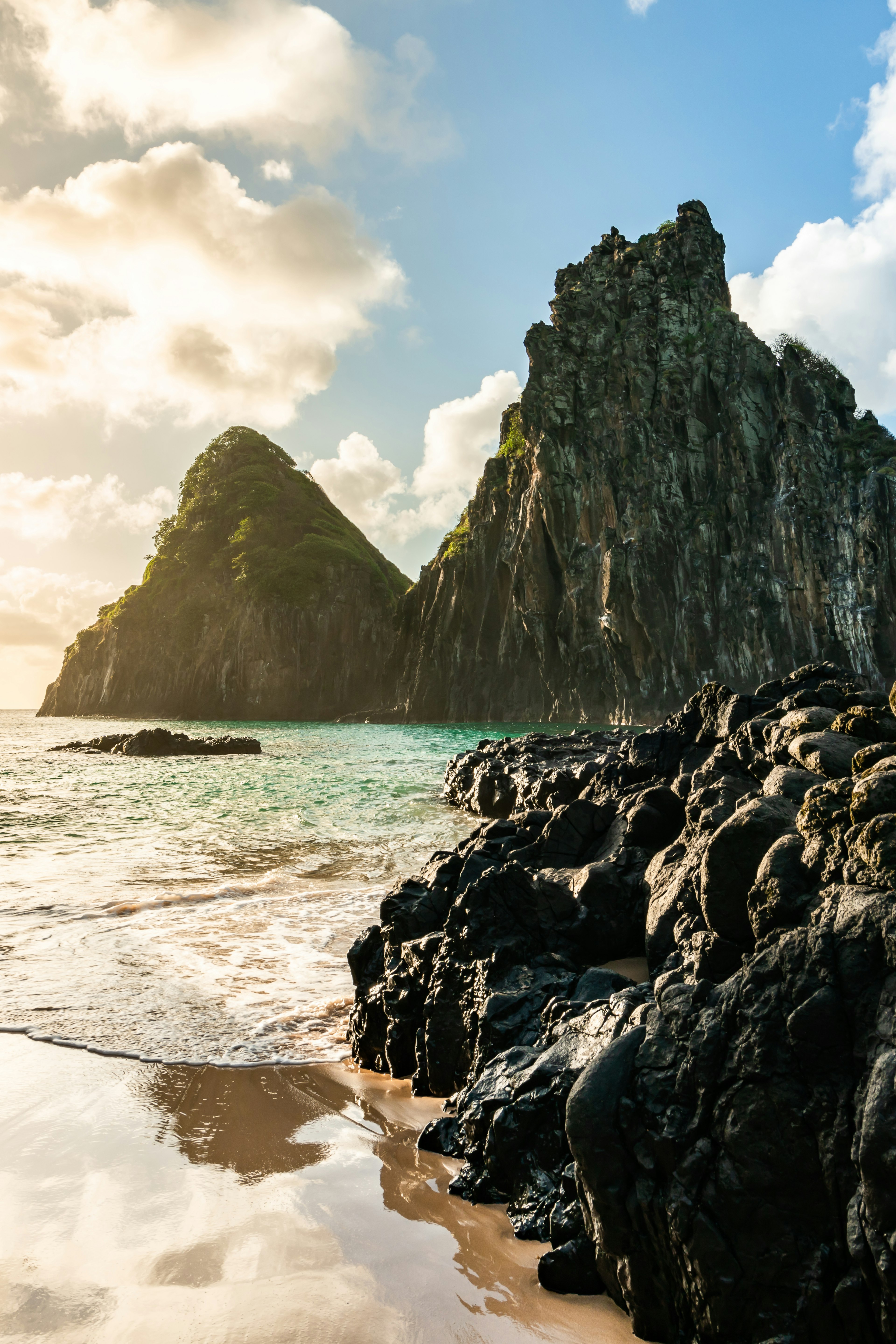 Sunset at Cacimba do Padre beach with Dois Irmaos Hill and turquoise water in Fernando de Noronha