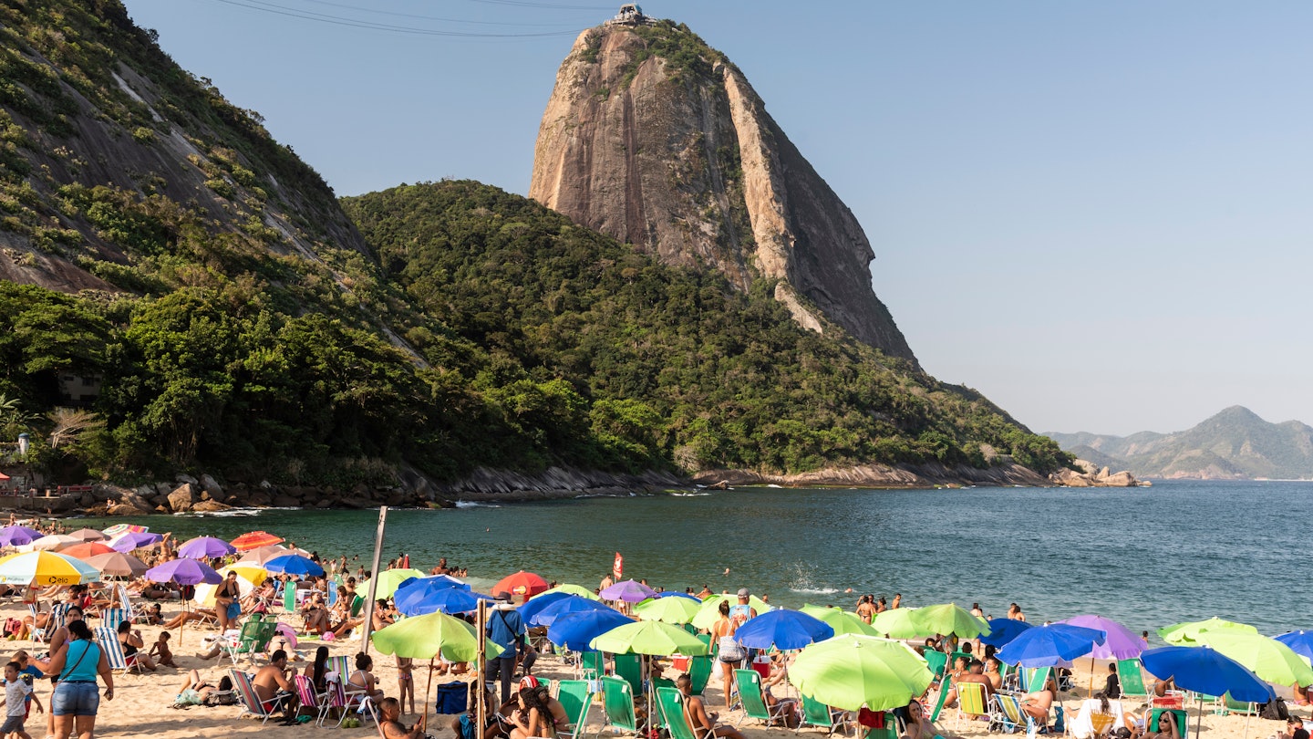 RIO DE JANEIRO, BRAZIL - OCTOBER 19, 2020: Beautiful view to Sugar Loaf Mountain and beach people with umbrellas, License Type: media, Download Time: 2025-02-28T21:36:25.000Z, User: rhylton_redventures, Editorial: true, purchase_order: 56530 - Guidebooks, job: Lonely Planet WIP, client: Lonely Planet WIP, other: Rhianydd Hylton