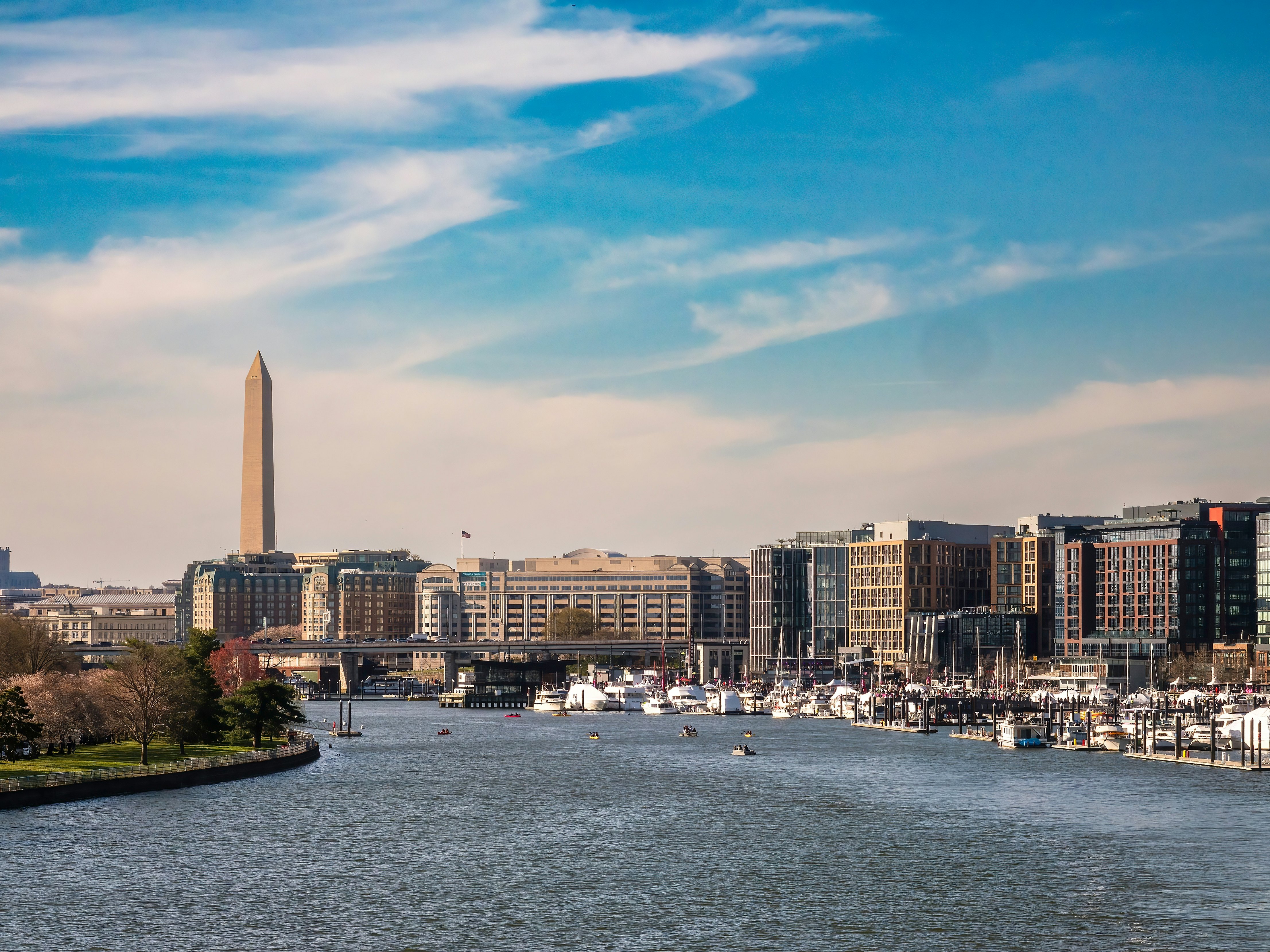 Late afternoon view of Southwest Waterfront, with marinas and hotels in The Wharf entertainment district, along the Potomac River. (Washington Monument at left.)