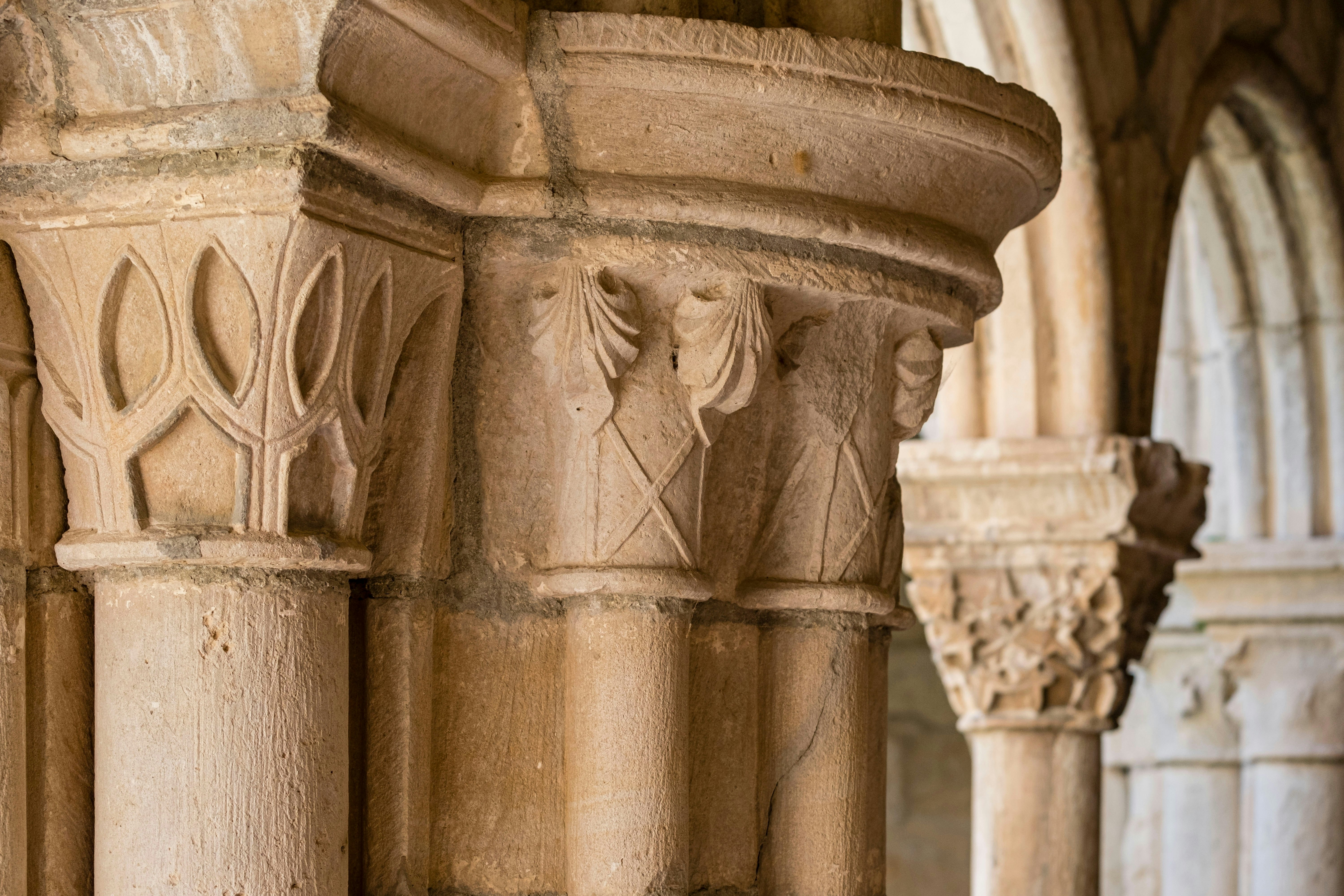 Detailed stonework on columns within a monastery.