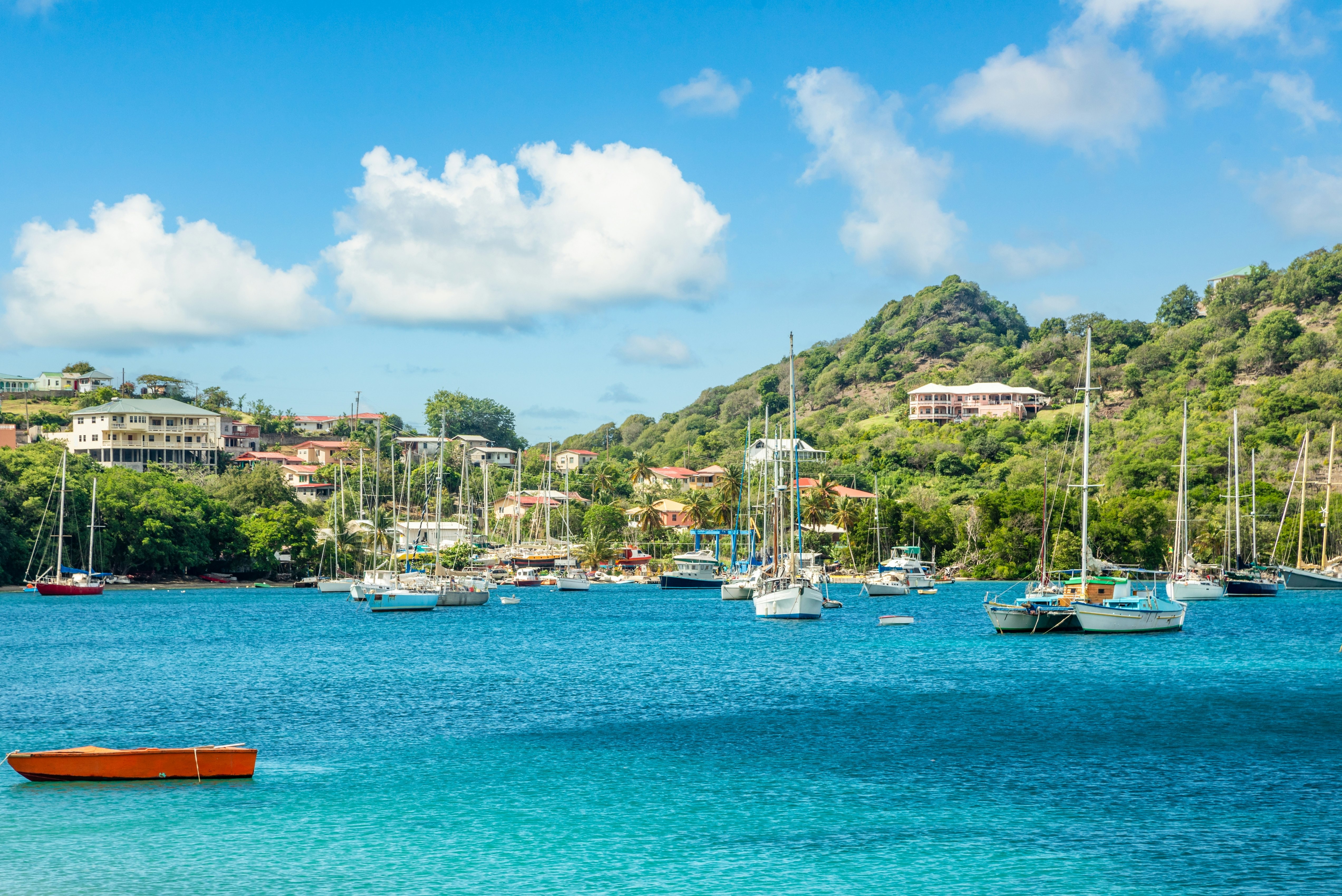 Turquoise colored sea with anchored yachts and boats in the lagoon