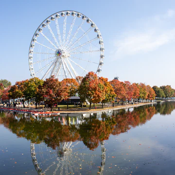 The wheel at old port in Montreal on an early autumn day with a reflection in the water and bright autumn colours , License Type: media, Download Time: 2025-04-25T16:06:56.000Z, User: katelyn.perry_lonelyplanet, Editorial: false, purchase_order: 65050 - Digital Destinations and Articles, job: wip, client: wip, other: Katelyn Perry