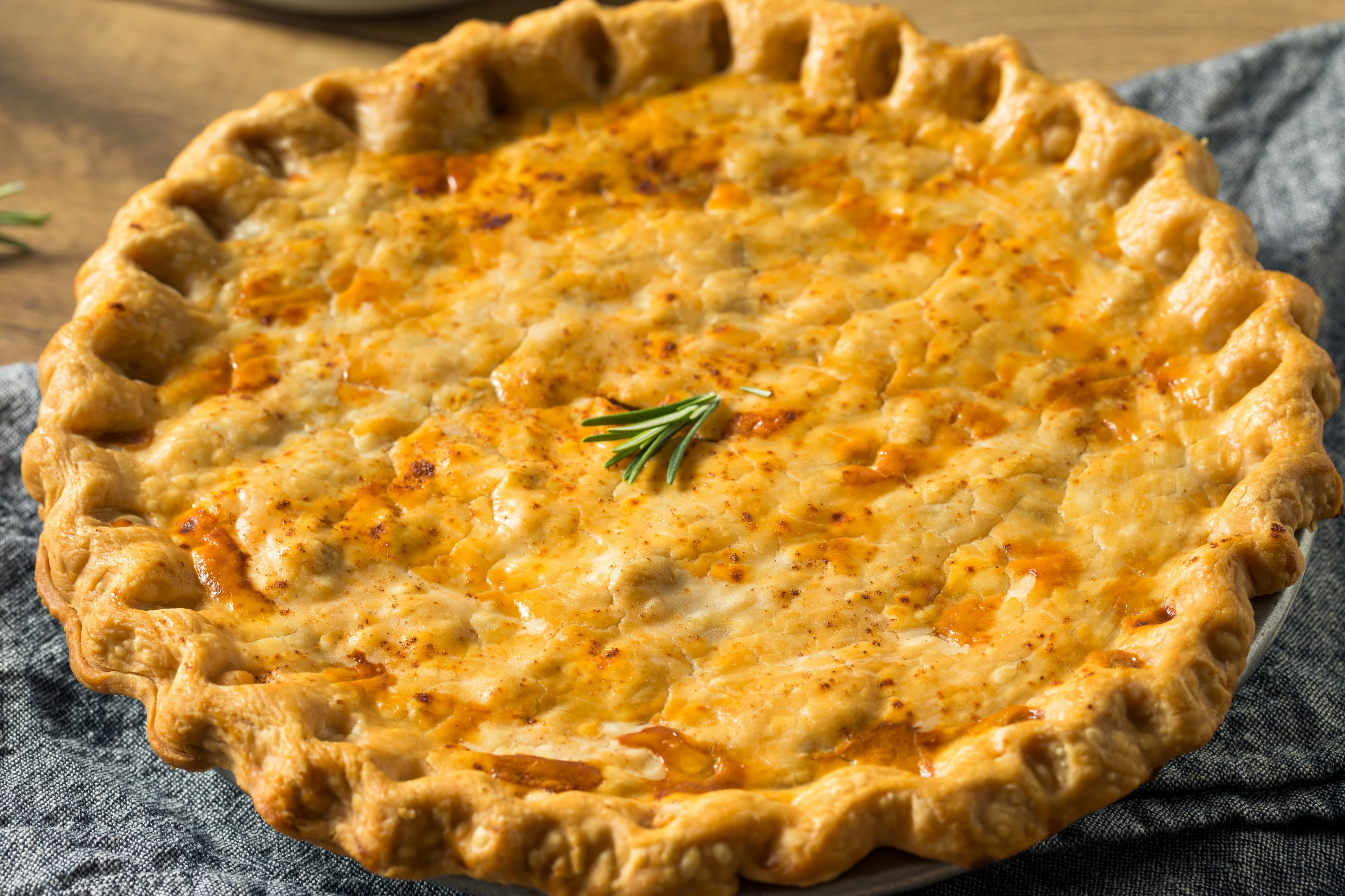 This photo captures the savory delight of tourtière, a traditional French-Canadian meat pie. Made with a flaky pastry crust and a rich, seasoned filling of ground pork, beef, and spices.