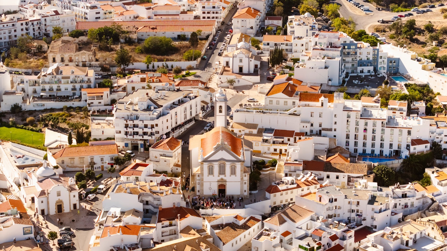 Aerial View of residential houses and Mother Church in Albufeira, Portugal, License Type: media, Download Time: 2025-09-17T12:01:44.000Z, User: bhealy950, Editorial: false, purchase_order: 65050 - Digital Destinations and Articles, job: Lonely Planet Online Editorial, client: Best things to do in Albufeira, other: Brian Healy