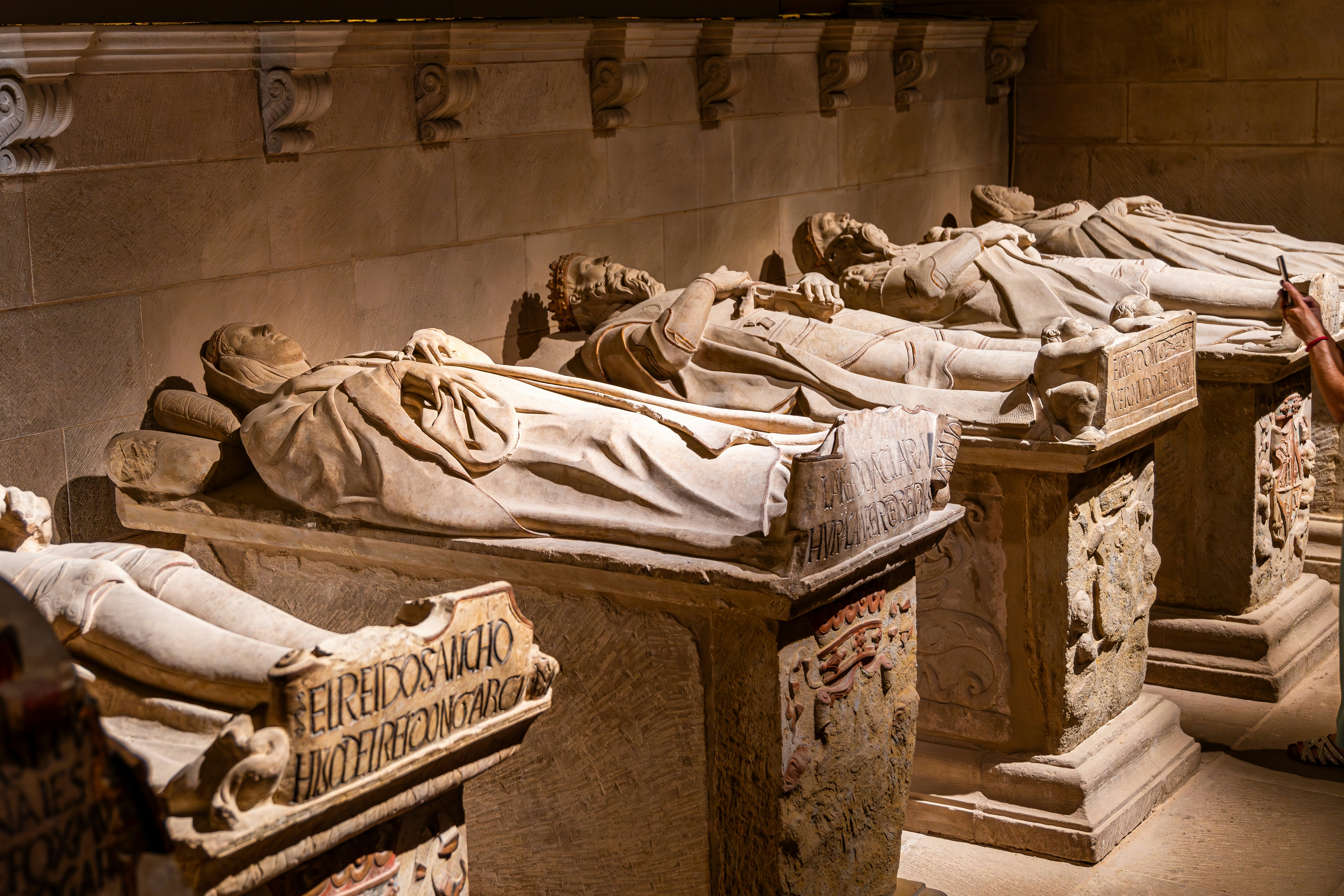 Tombs with marble statues of people lying on them in the Royal Pantheon of Santa María la Real inside the Catedral of Santa María.