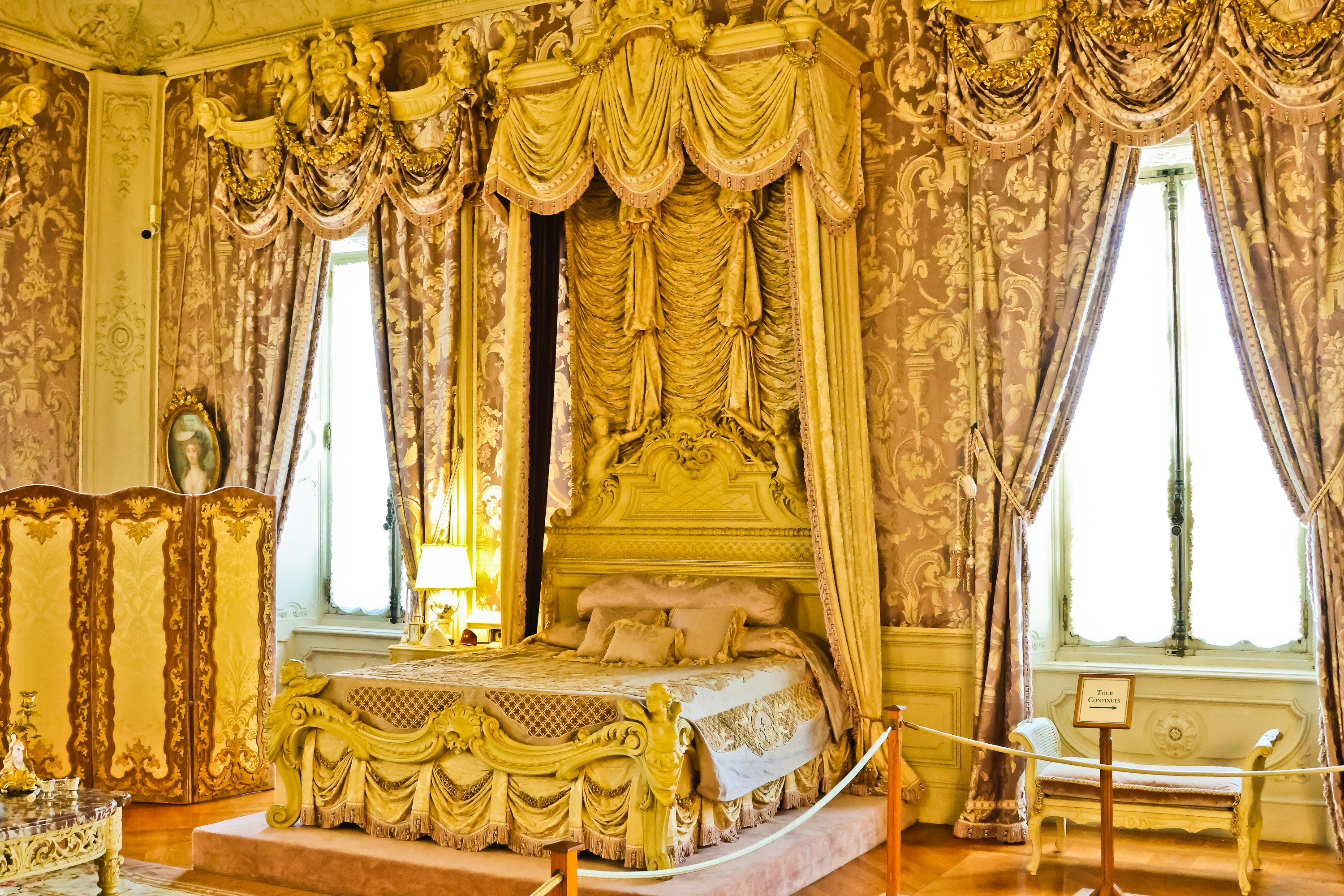 An ornate bedroom decorated in shades of gold.