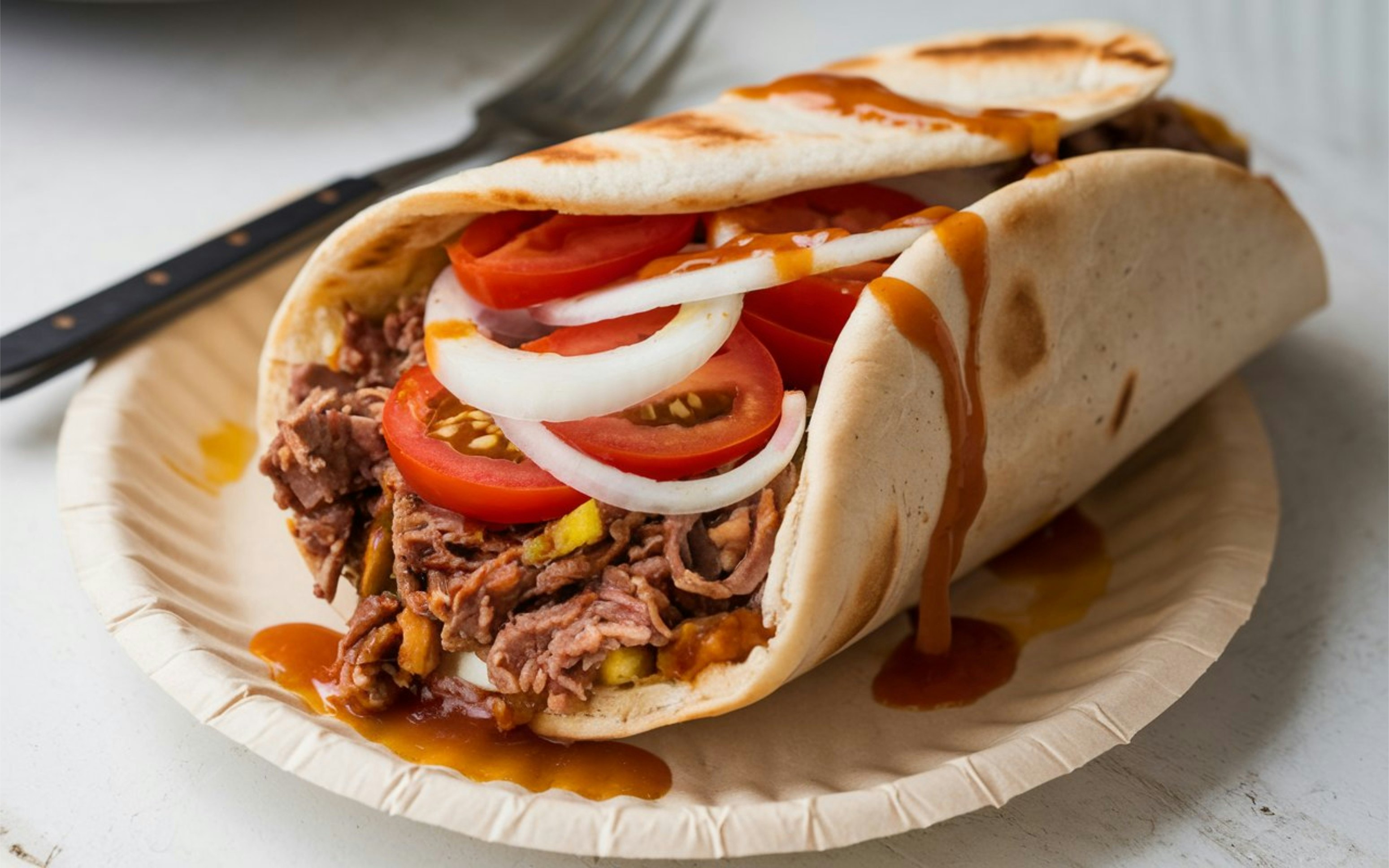 Donair: Halifax’s take on doner kebab: spiced beef wrapped in pita with sweet garlic sauce and onions. Late-night Canadian street food favorite.
