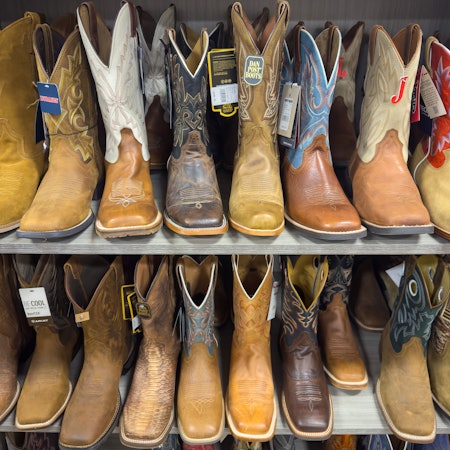 A row of traditional authentic cowboy boots for sale in a store in Austin, TX