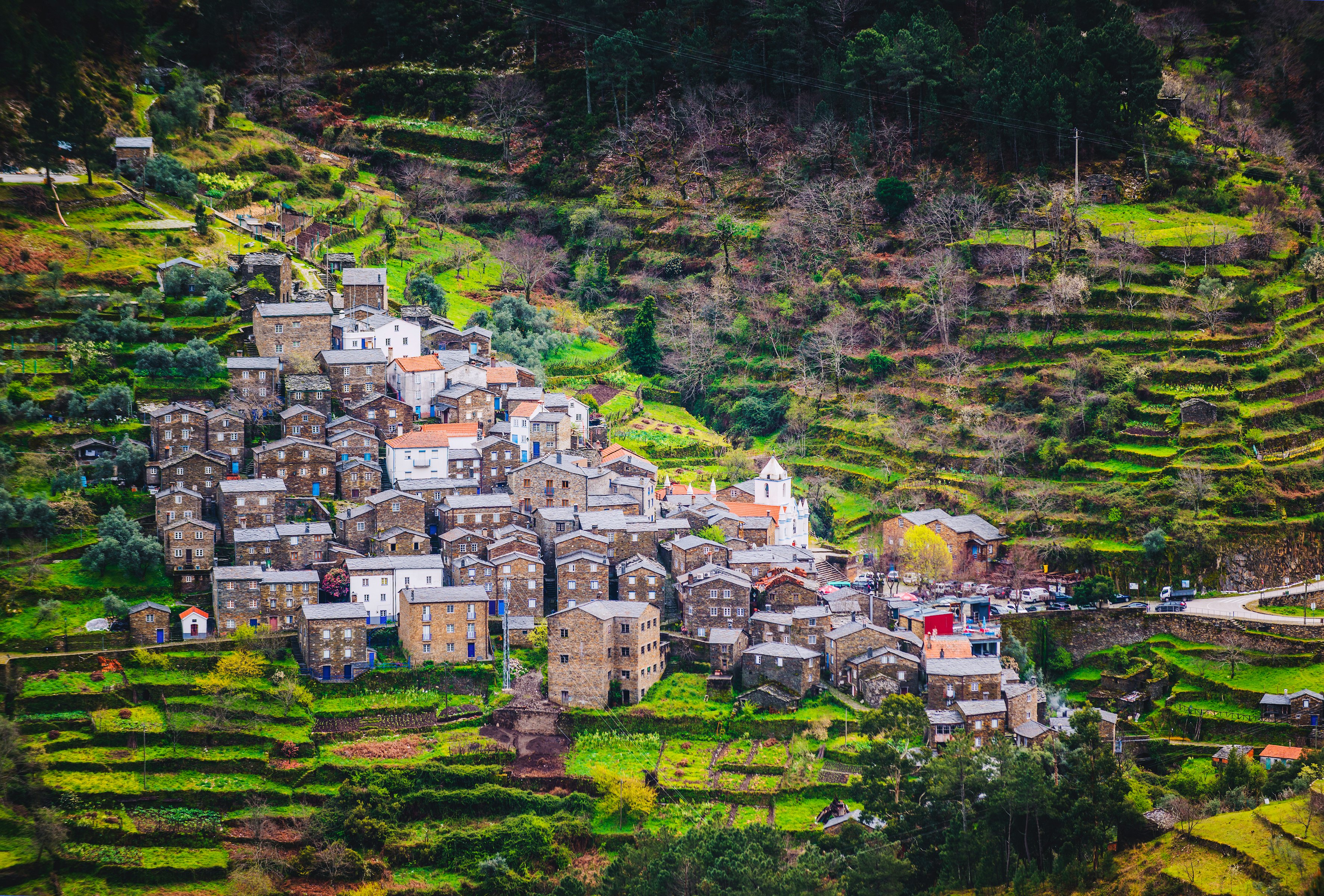 A traditional village of stone houses built into a stepped hillside.
