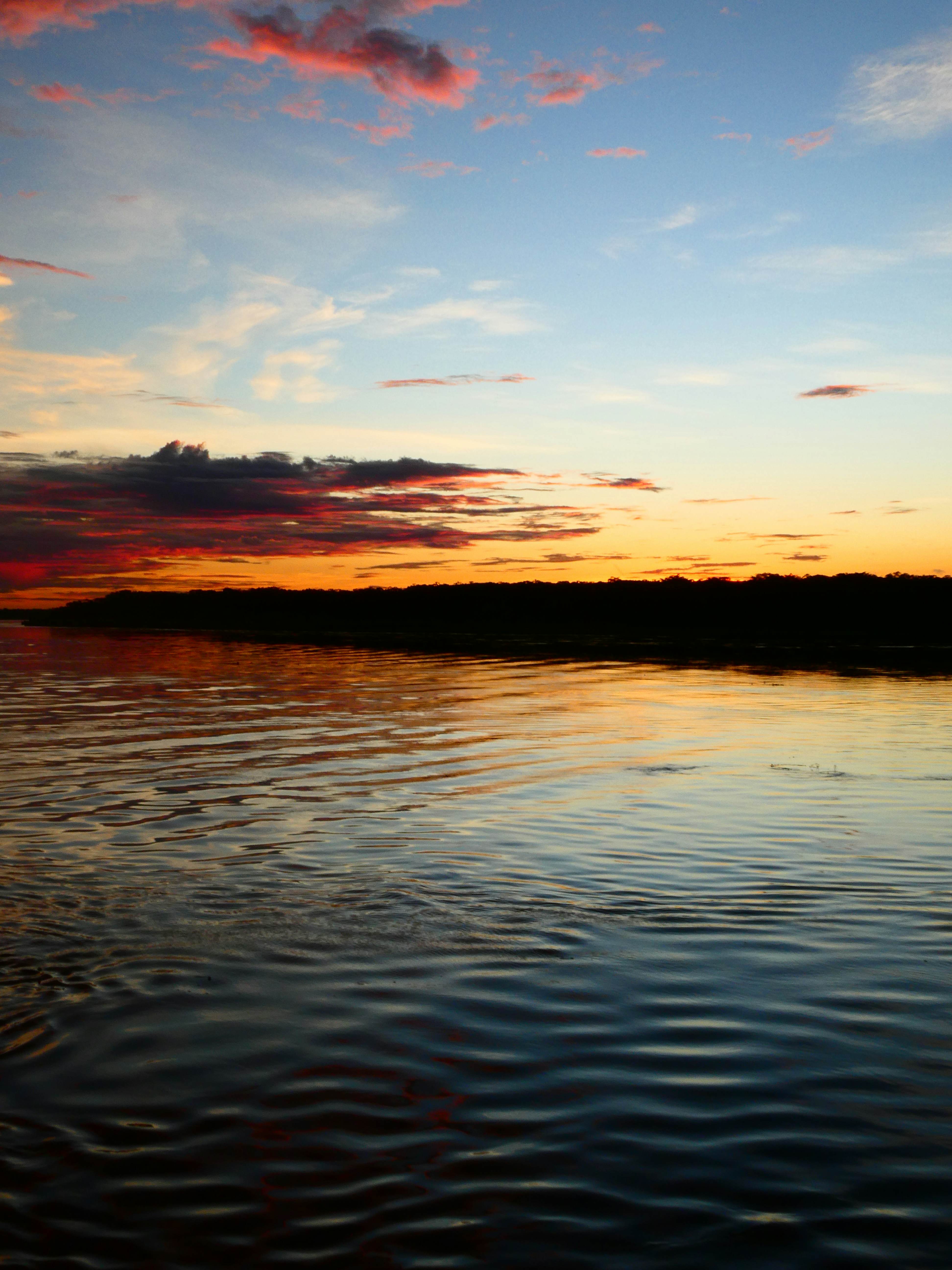 Rippling water under an orange and blue sky in Brazil.