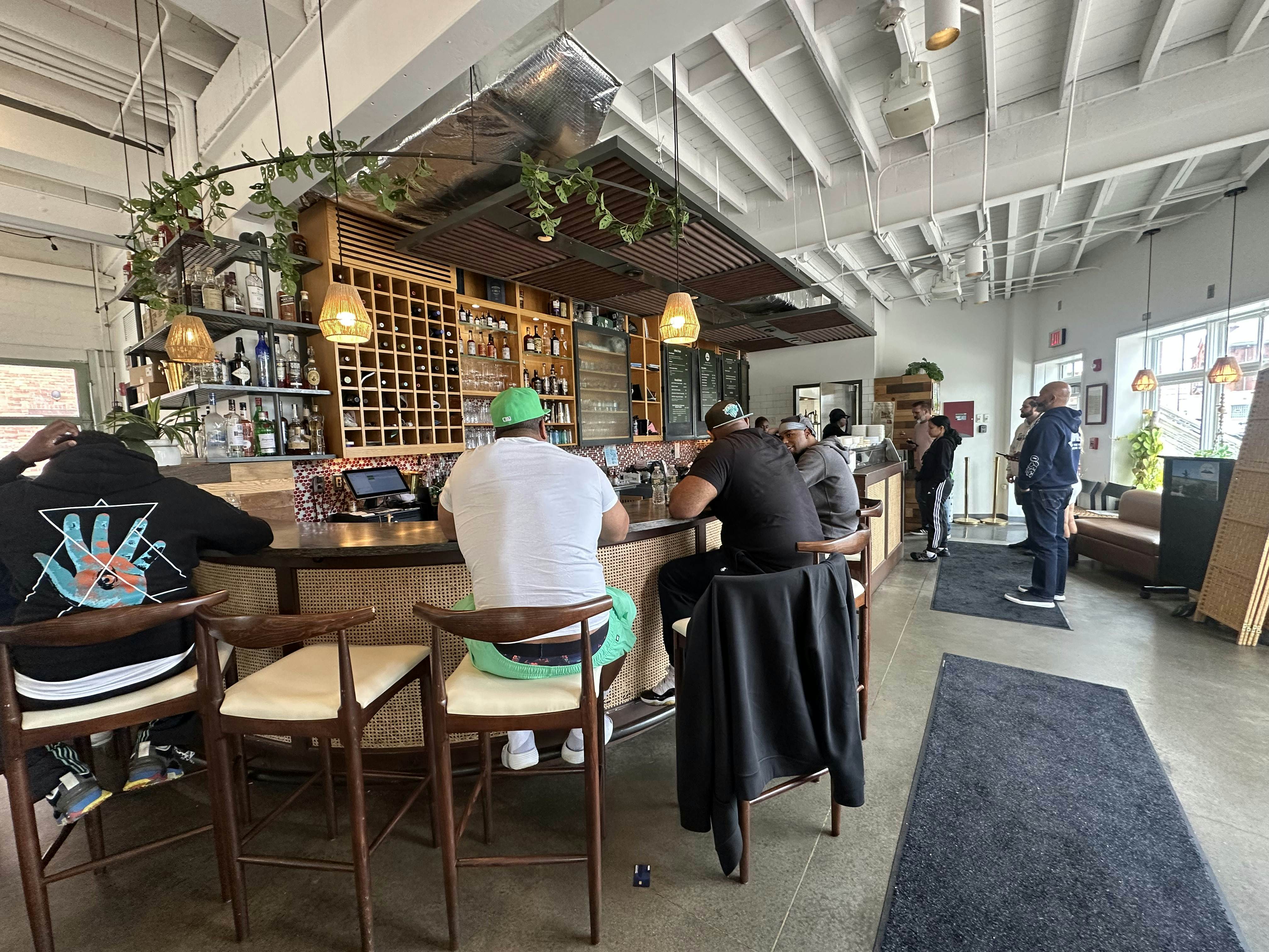 Men enjoying their meal sitting a restaurant bar