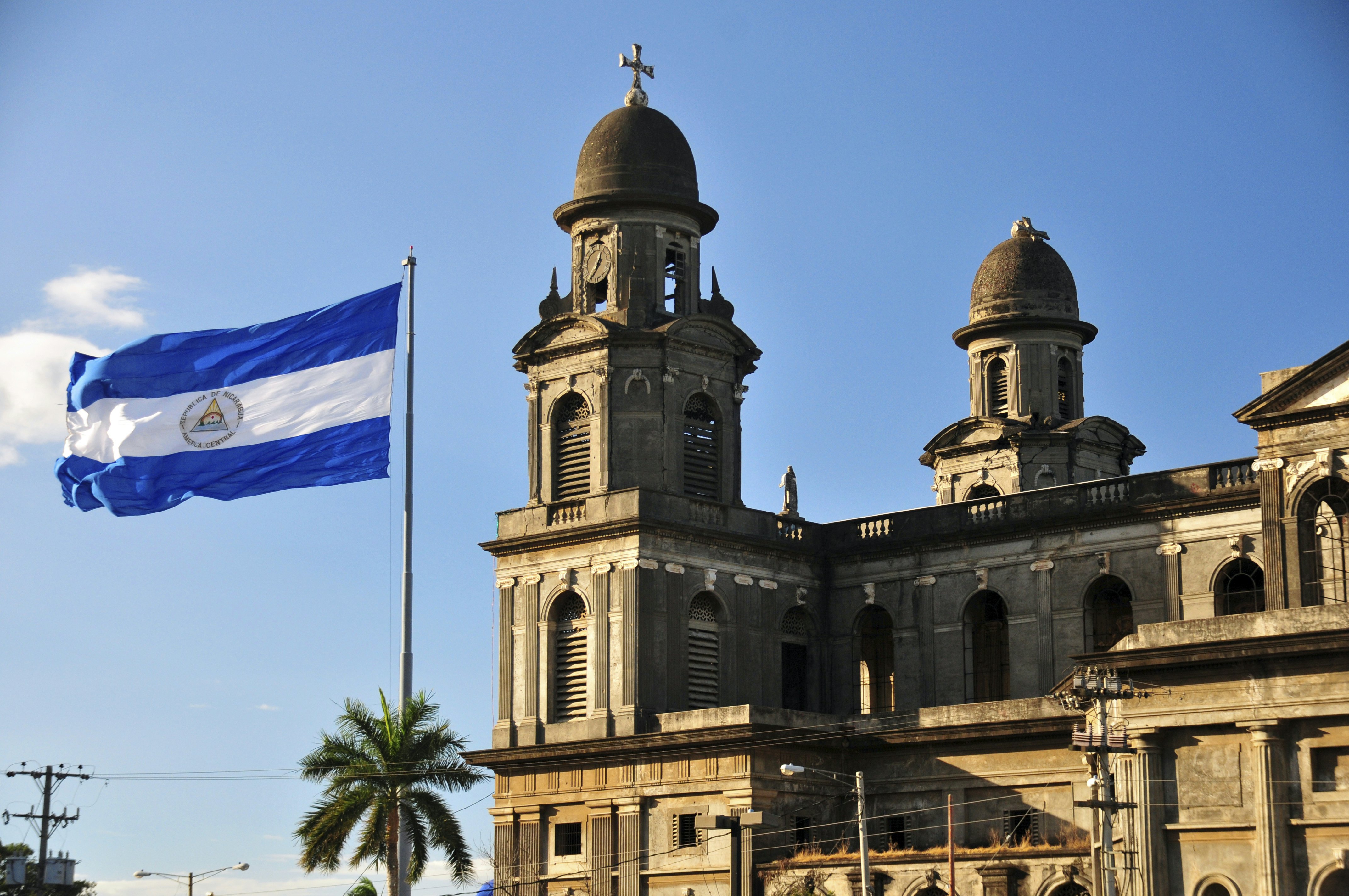 Old cathedral with the Nicaraguan flag flying outside