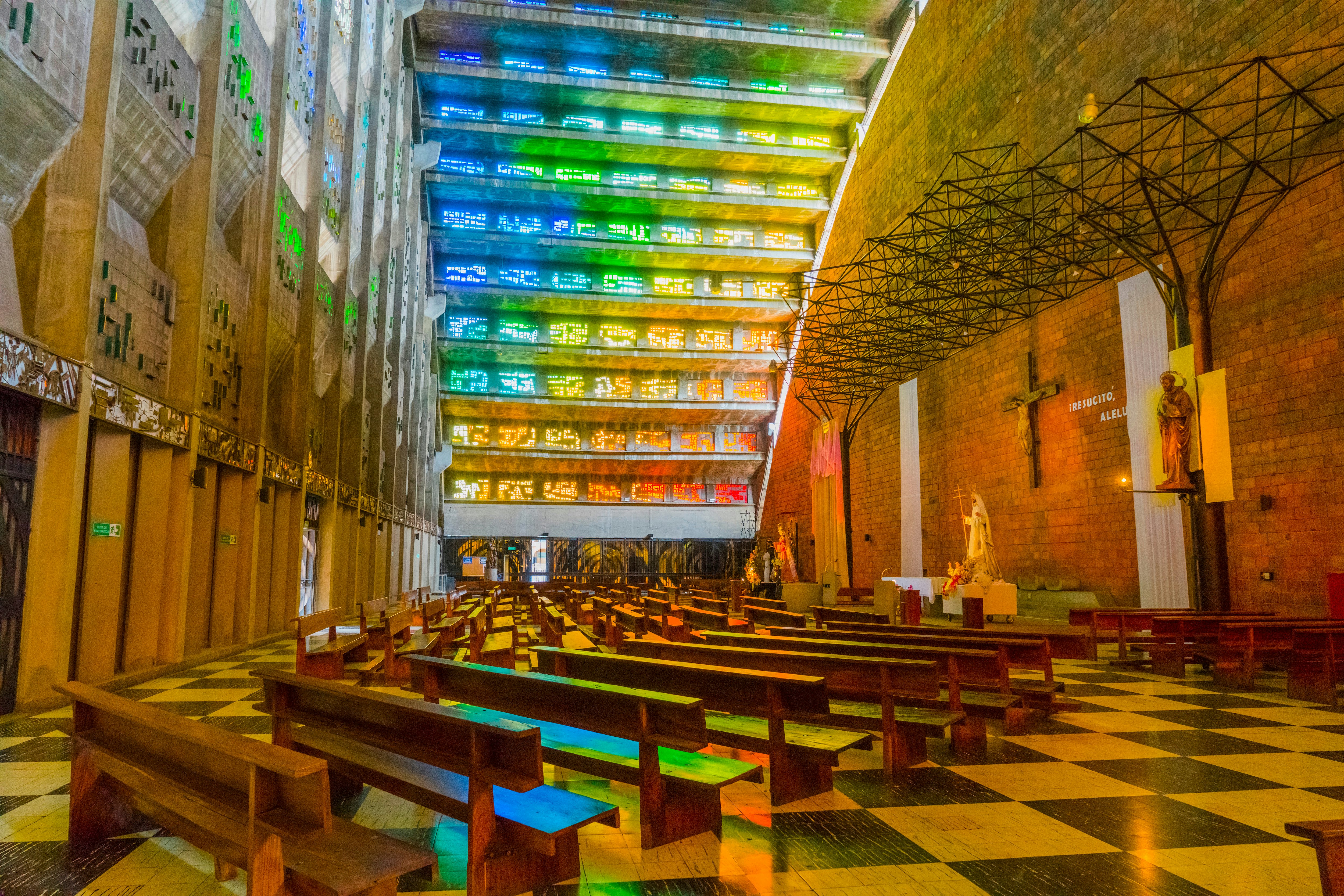 A rainbow of stained glass inside a church