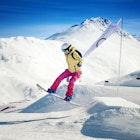 Woman snowboarding on a sunny day in the ski resort of Livigno - Italy  License Type: media  Download Time: 2021-11-11T06:50:10.000Z  User: mvm_lonelyplanet  Is Editorial: No  purchase_order: