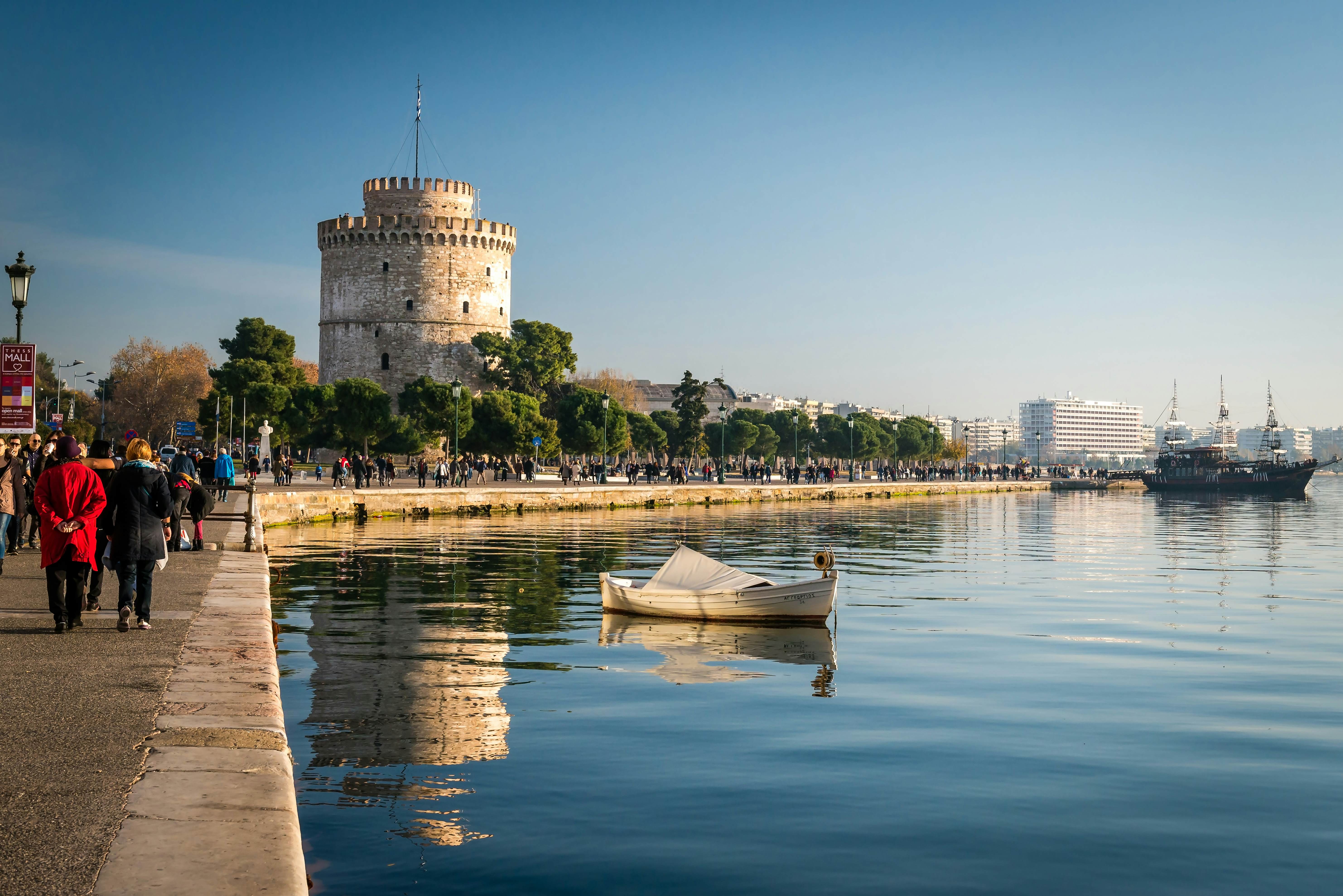Thessaloniki, Greece - December 24, 2015: People walking on the coast in Thessaloniki next to the white tower which which once guarded the eastern end of the city's sea walls  License Type: media  Download Time: 2023-01-28T12:53:50.000Z  User: Norma.PrauseBrewer_LonelyPlanet  Is Editorial: Yes  purchase_order:   