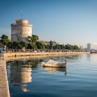Thessaloniki, Greece - December 24, 2015: People walking on the coast in Thessaloniki next to the white tower which which once guarded the eastern end of the city's sea walls  License Type: media  Download Time: 2023-01-28T12:53:50.000Z  User: Norma.PrauseBrewer_LonelyPlanet  Is Editorial: Yes  purchase_order: