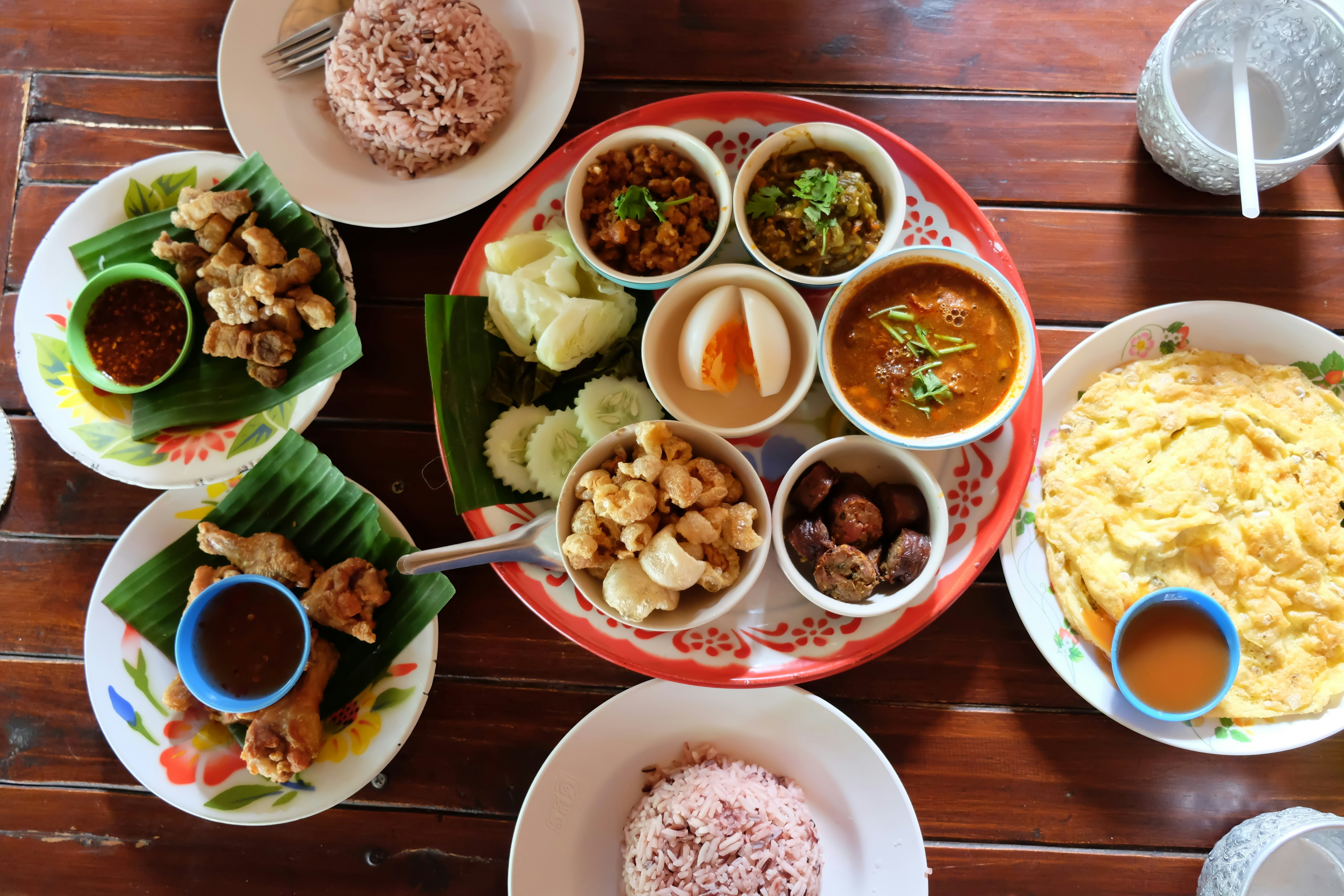 An assortment of plated Chiang Mai cuisine on a wooden table