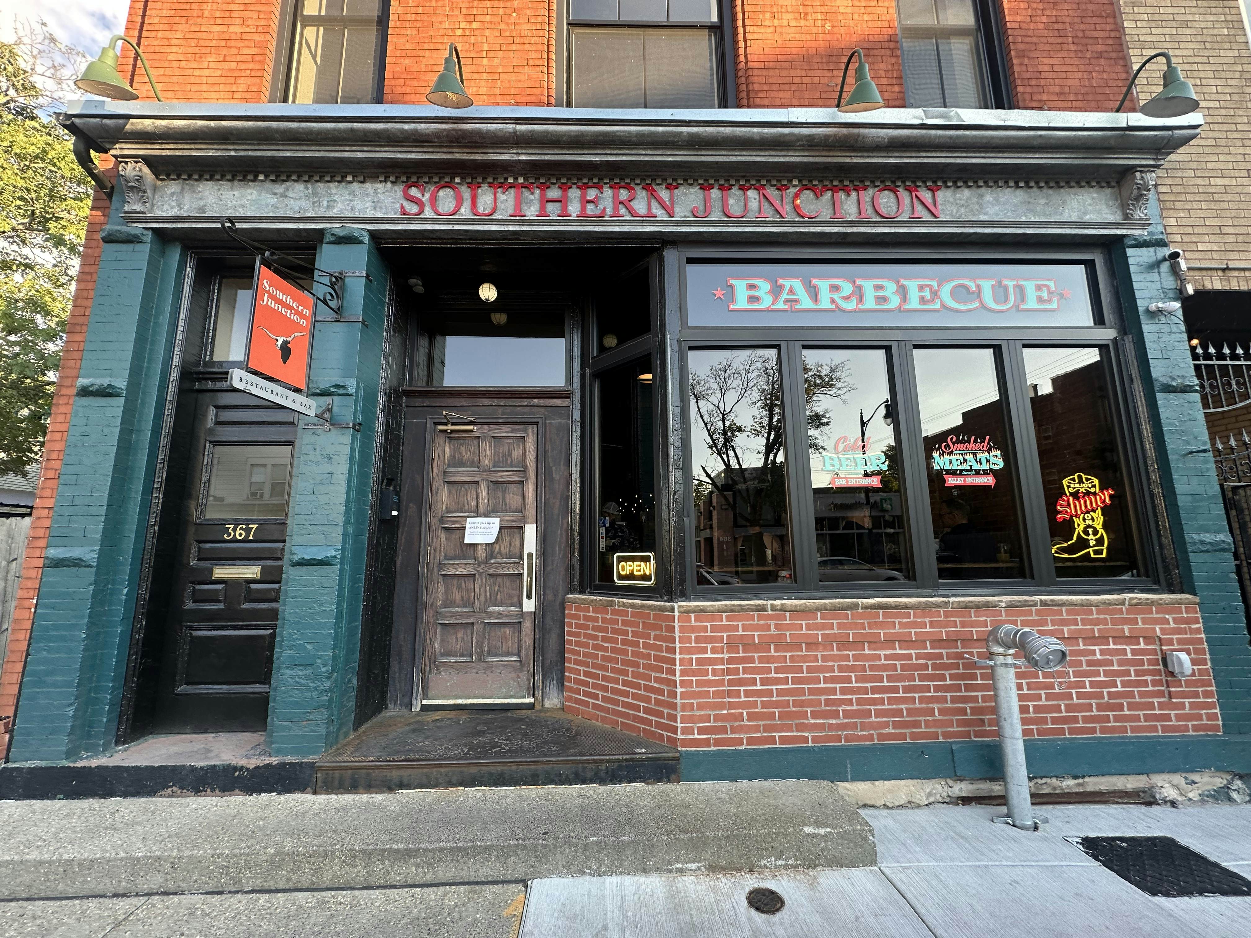The outside of a brick building with a sign reading Southern Junction Barbecue
