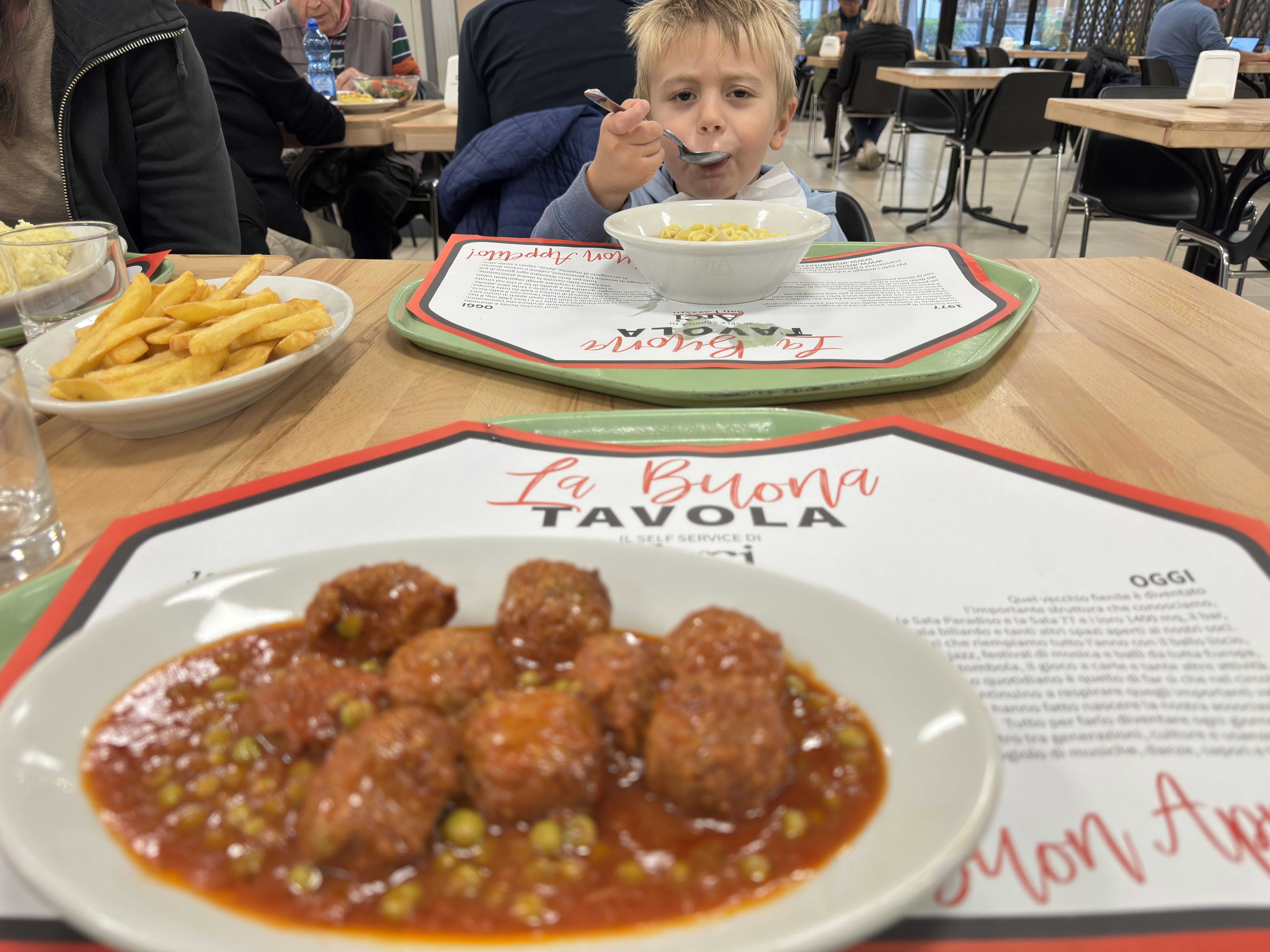Meatballs and peas and Kevin's son at ARCI San Lorenzo in Bologna Italy