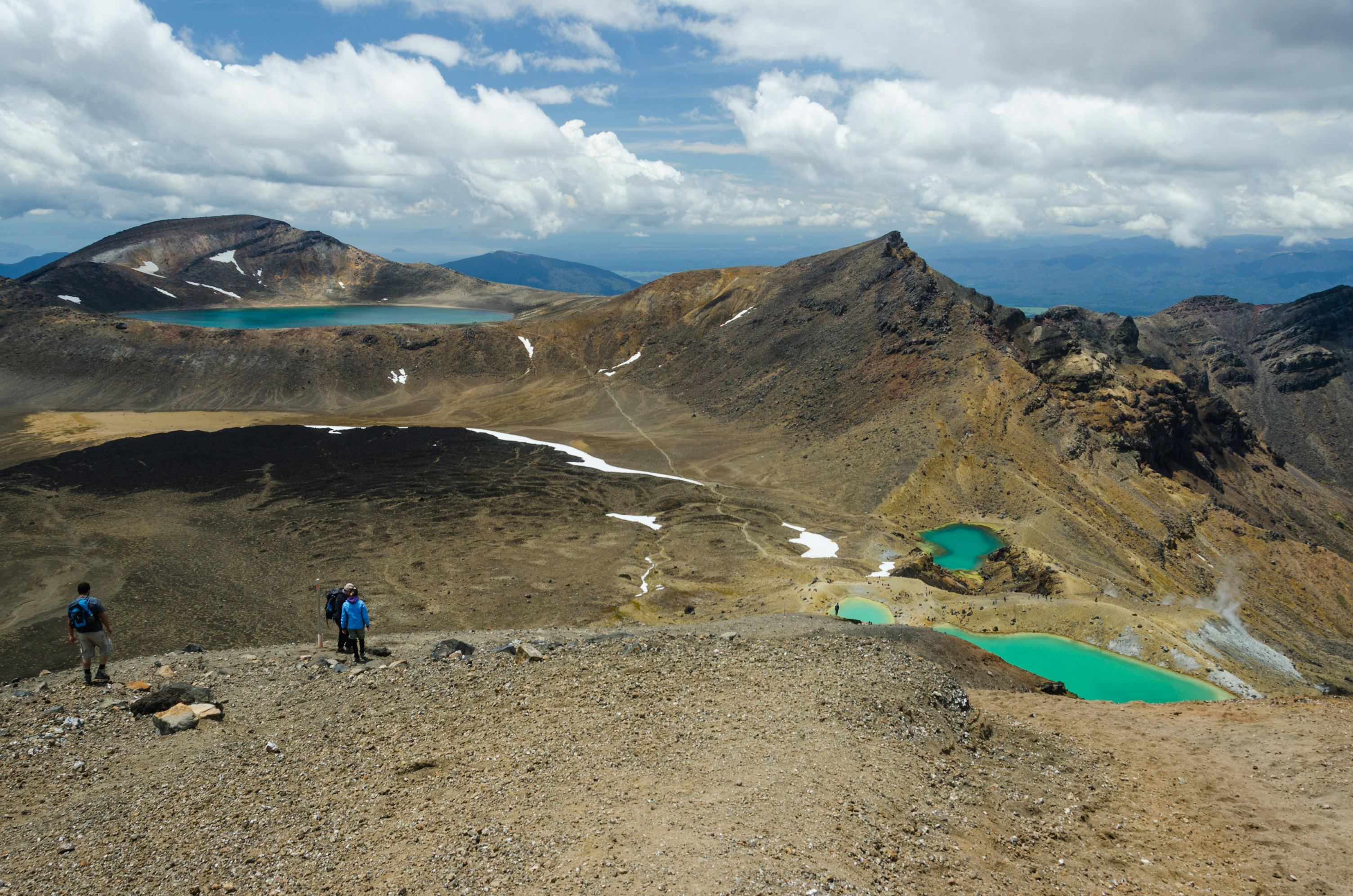 Hikers walking the Tongariro Alpine Crossing. Tongariro National Park, New Zealand.
