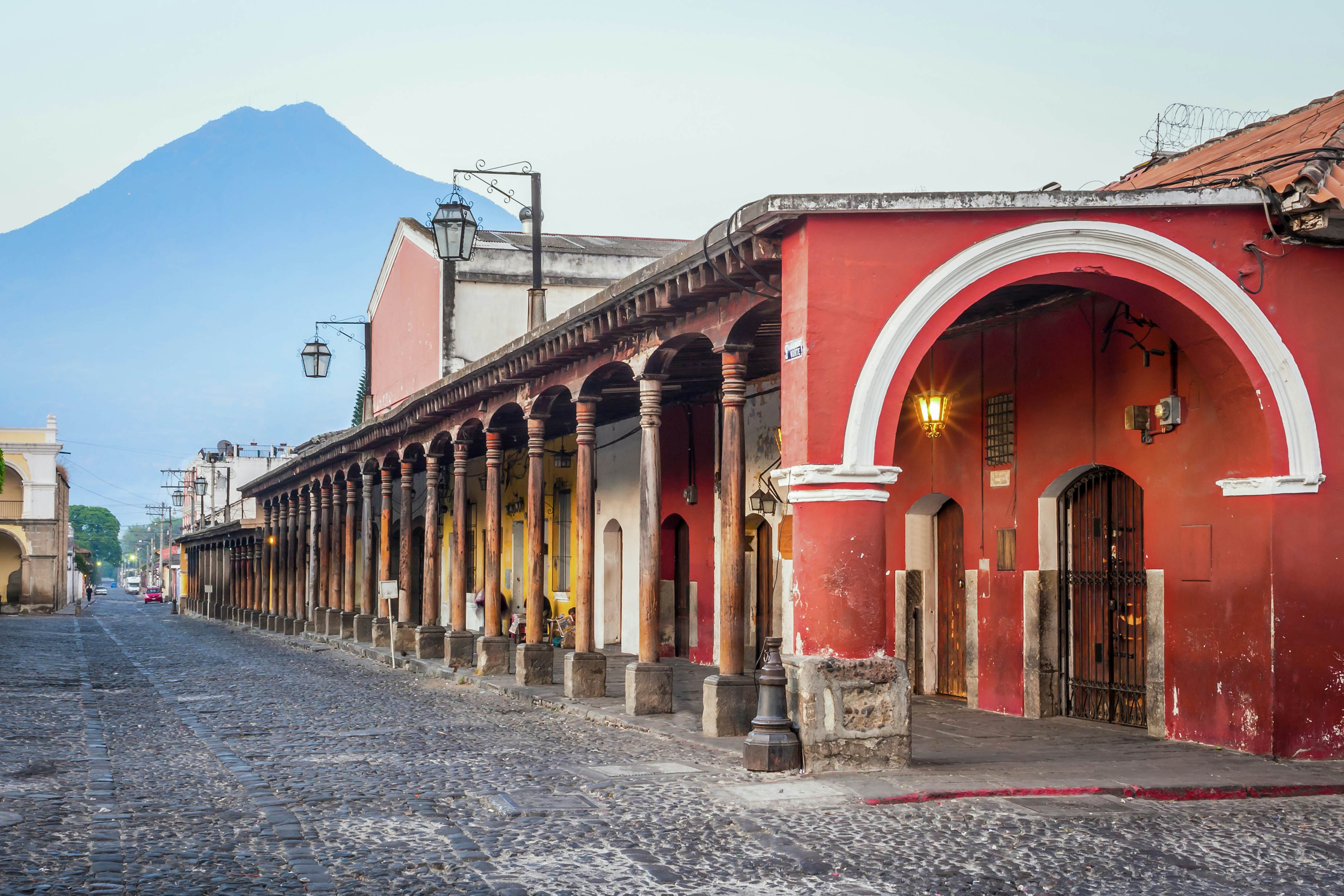 View of colonial buildings in Antigua central park with view of 'Agua' volcano in background, License Type: media, Download Time: 2025-05-17T15:04:56.000Z, User: nic.dhoedt_lonelyplanet, Editorial: false, purchase_order: 56530 - Guidebooks, job: Global Publishing WIP, client: Lonely Planet Central America 11, other: Nicolas D'Hoedt