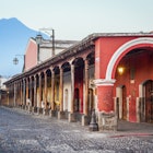 View of colonial buildings in Antigua central park with view of 'Agua' volcano in background, License Type: media, Download Time: 2025-05-17T15:04:56.000Z, User: nic.dhoedt_lonelyplanet, Editorial: false, purchase_order: 56530 - Guidebooks, job: Global Publishing WIP, client: Lonely Planet Central America 11, other: Nicolas D'Hoedt