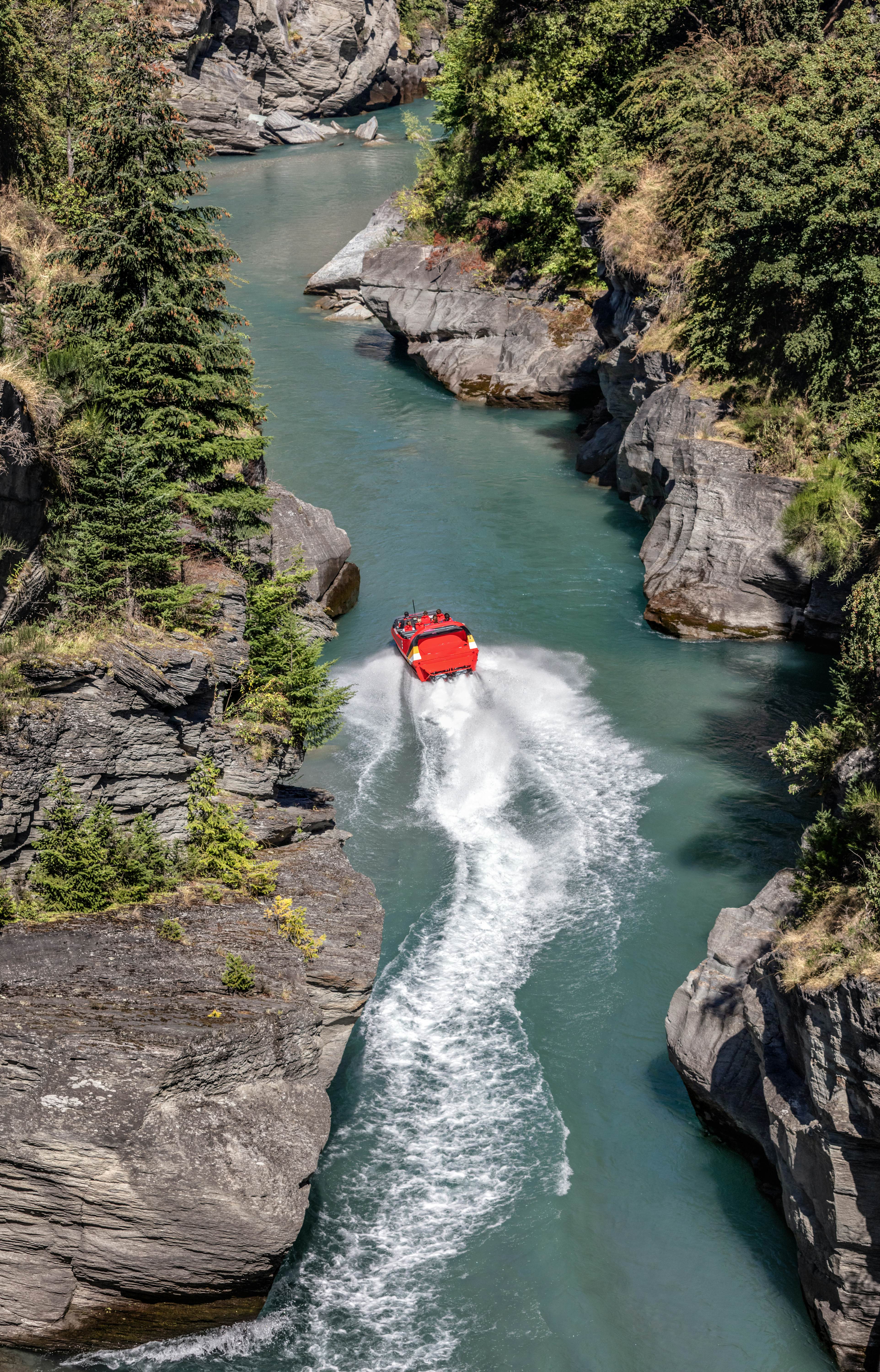 Tourists enjoy a high-speed boat ride on Shotover river near Queenstown. Queenstown is a recognized center of extreme entertainment. South Island of New Zealand, License Type: media, Download Time: 2025-04-30T19:16:23.000Z, User: rhylton_redventures, Editorial: false, purchase_order: 65050 - Digital Destinations and Articles, job: Lonely Planet, client: wip, other: Rhianydd Hylton