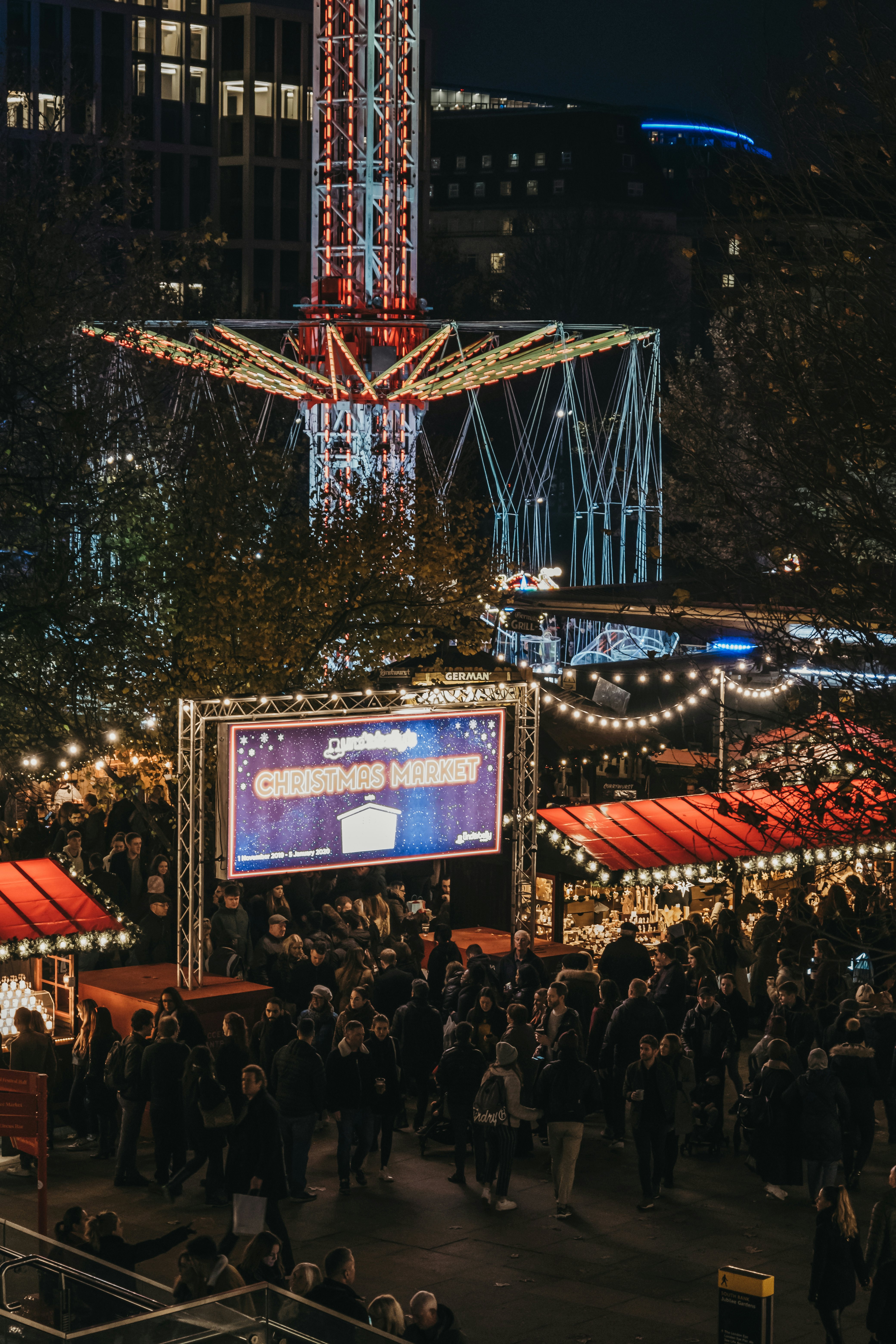 High angle view of people in Southbank Centre Winter Market, an outdoor, global street food market, focused on sustainable and artisan produce.,