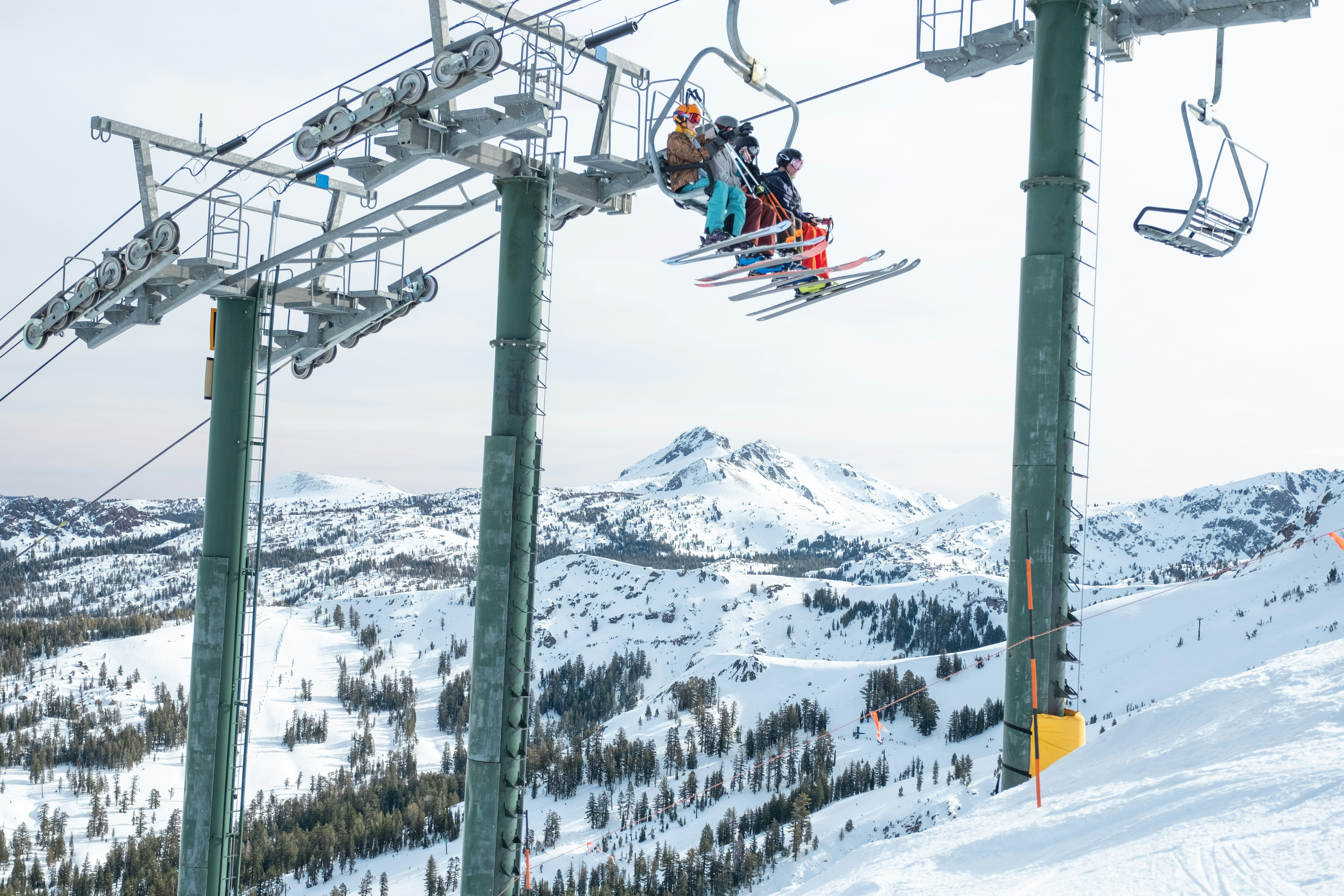 A group of skiers going up a lift.
