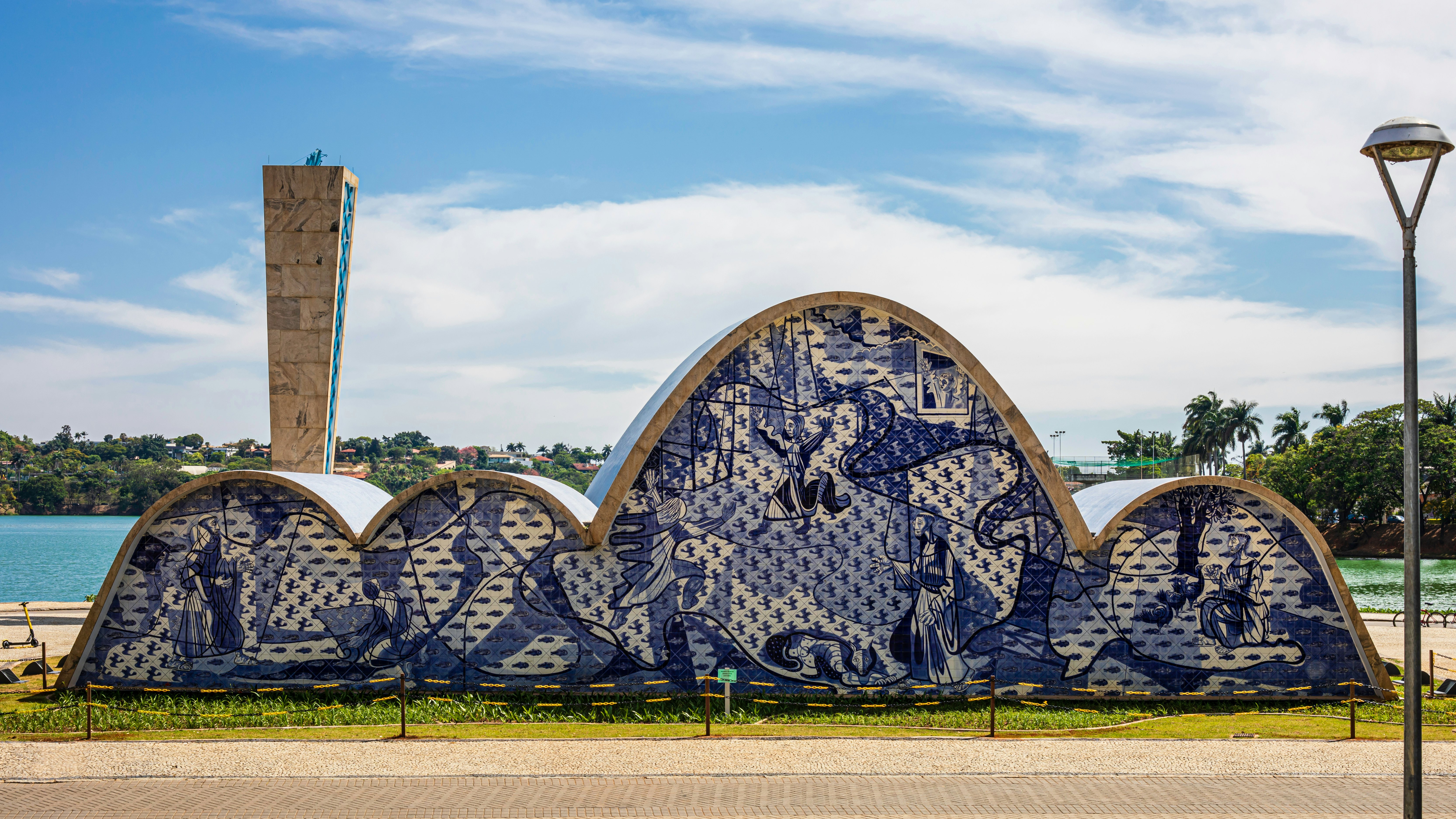 An unusually designed church with an undulating roof. Paintings in shades of blue adorn its entire facade