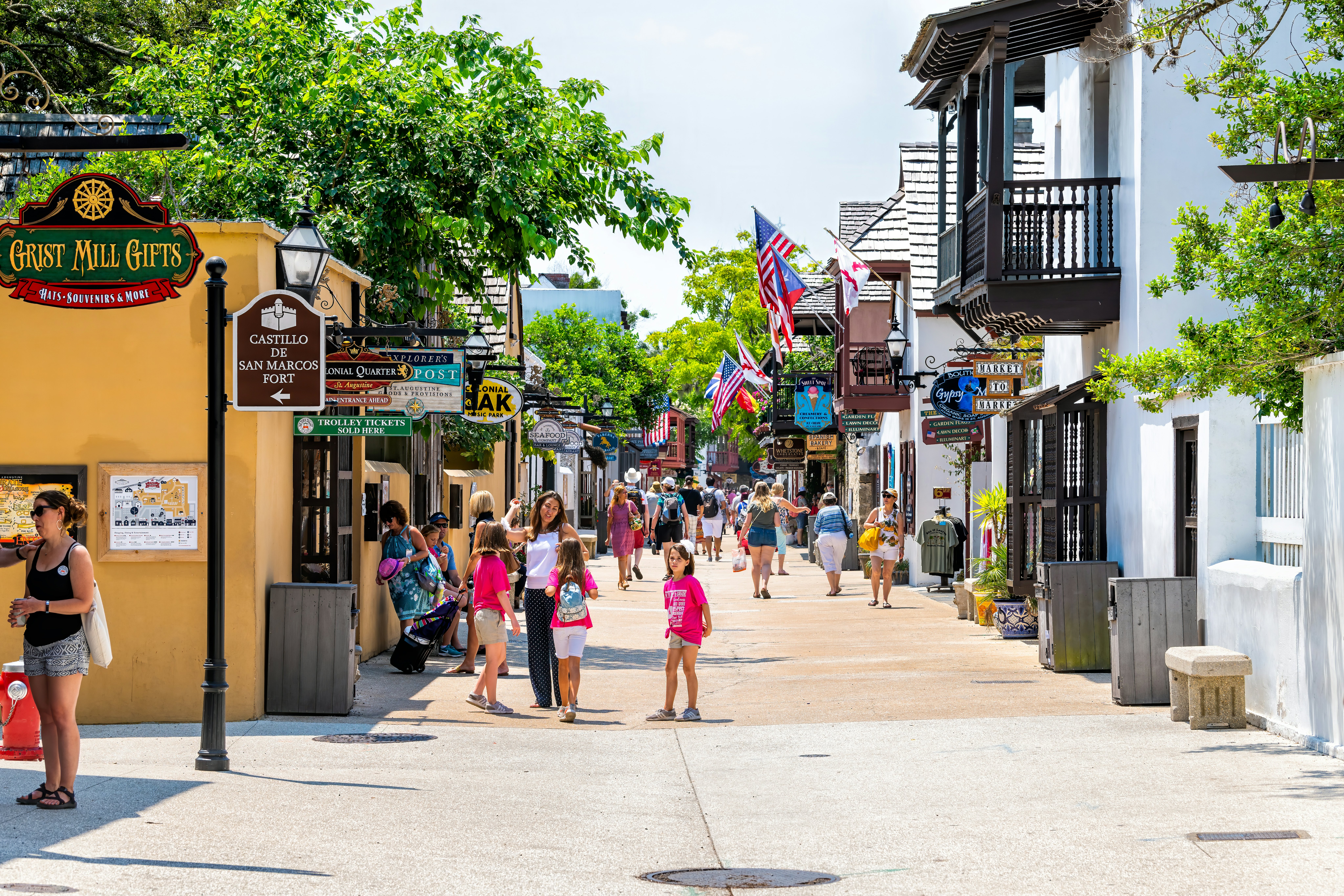 People walking and shopping on St George Street in St Augustine on summer day by stores shops and restaurants in old town Colonial quarter