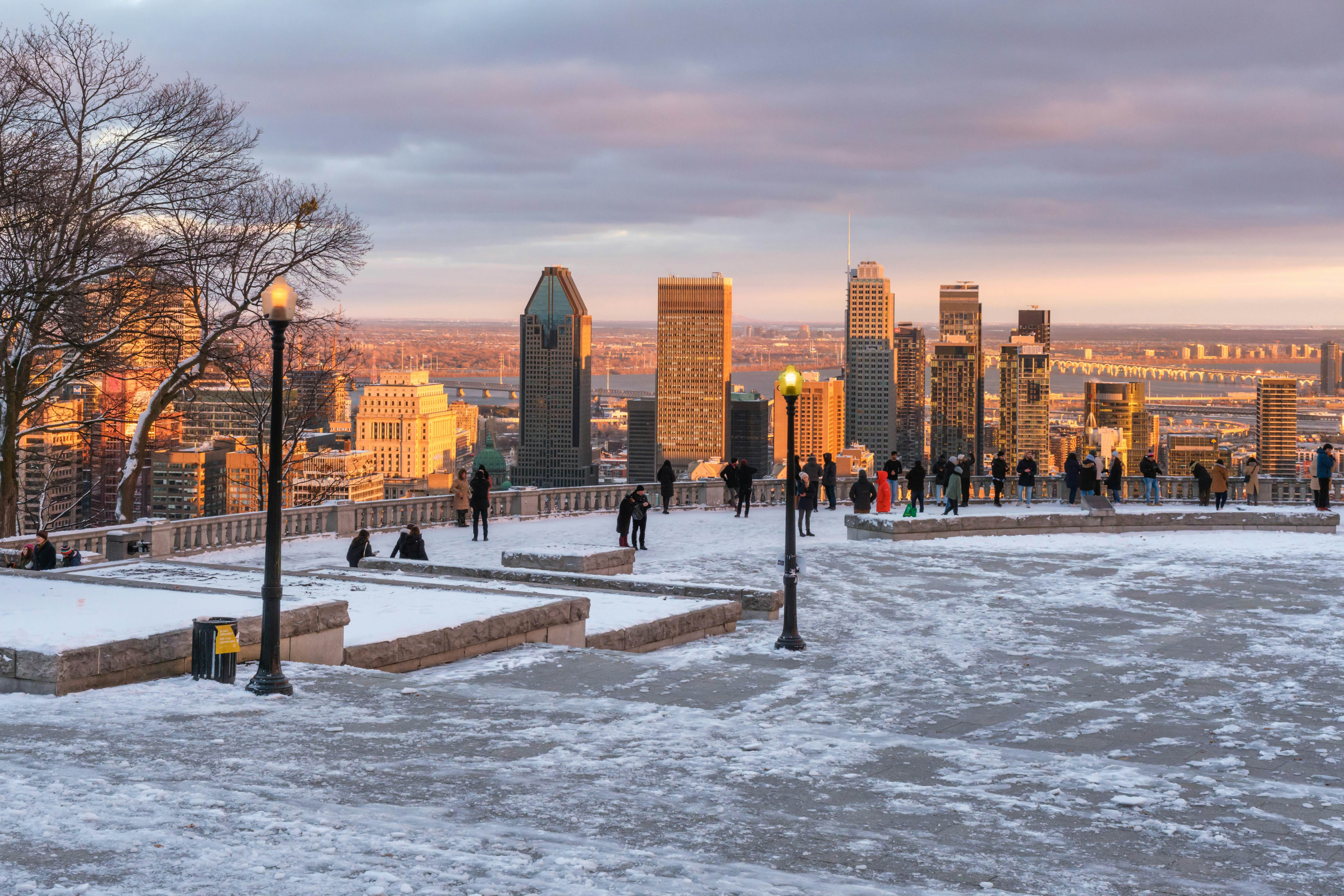 Montreal, Canada - 27 November 2021: Tourists looking at Montreal Skyline from Kondiaronk belvedere in winter., License Type: media, Download Time: 2025-09-04T19:37:34.000Z, User: katelyn.perry_lonelyplanet, Editorial: true, purchase_order: 65050 - Digital Destinations and Articles, job: wip, client: wip, other: Katelyn Perry